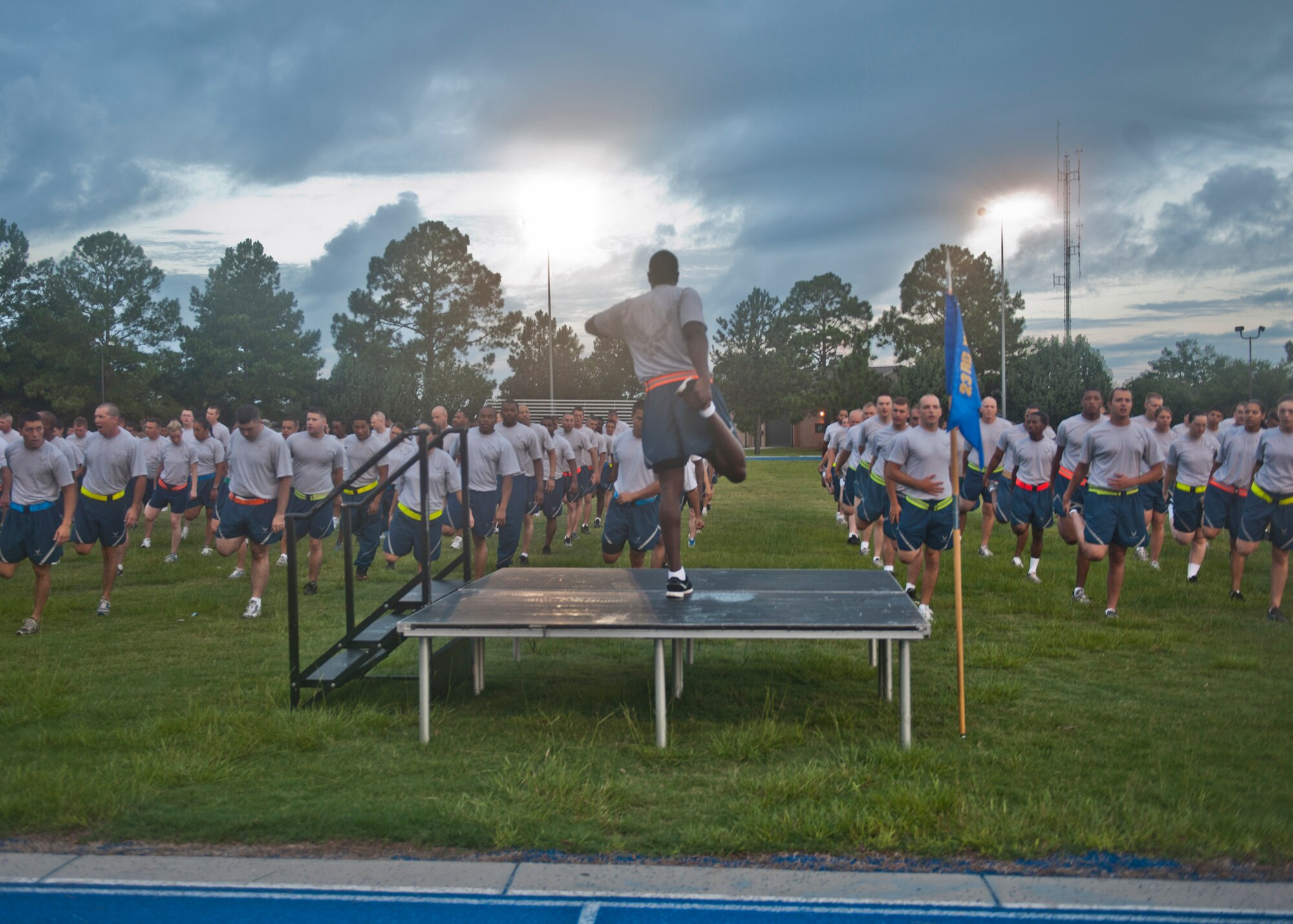 U.S. Air Force Staff Sgt. Thomas Watson, 23d Logistics Readiness Squadron , leads Airmen of the 23d Mission Support Group in stretches during the 23d MSG Fun Run July 20, 2012, at Moody Air Force Base, Ga. Prior to the run, a competition was held to see which squadron could demonstrate the most spirit for the chance to win the traveling “Tiger’s Pride Trophy,” which the 23d LRS won. (U.S. Air Force photo by Senior Airman Eileen Meier/Released)