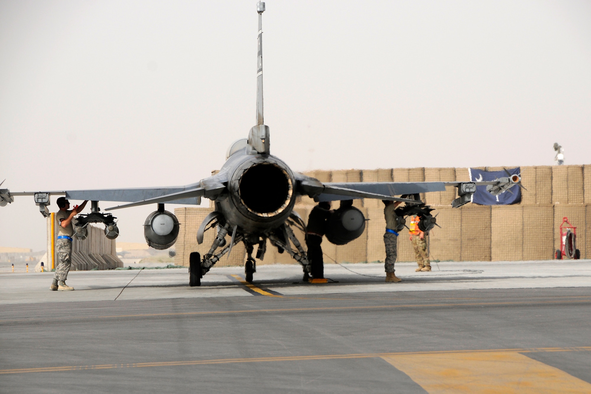 An F-16 with the 157th Expeditionary Fighter Squadron sits in the EOR at Kandahar Airfield as crew chiefs run through last minute checks as the jet readies for a day-time mission over Afghanistan on July 5, 2012.  Personnel are deployed from McEntire Joint National Guard Base, S.C., in support of Operation Enduring Freedom. Swamp Fox F-16's, pilots, and support personnel began their Air Expeditionary Force deployment in early April to take over flying missions for the air tasking order and provide close air support for troops on the ground in Afghanistan. (U.S. Air Force photo/Tech. Sgt. Stephen Hudson)