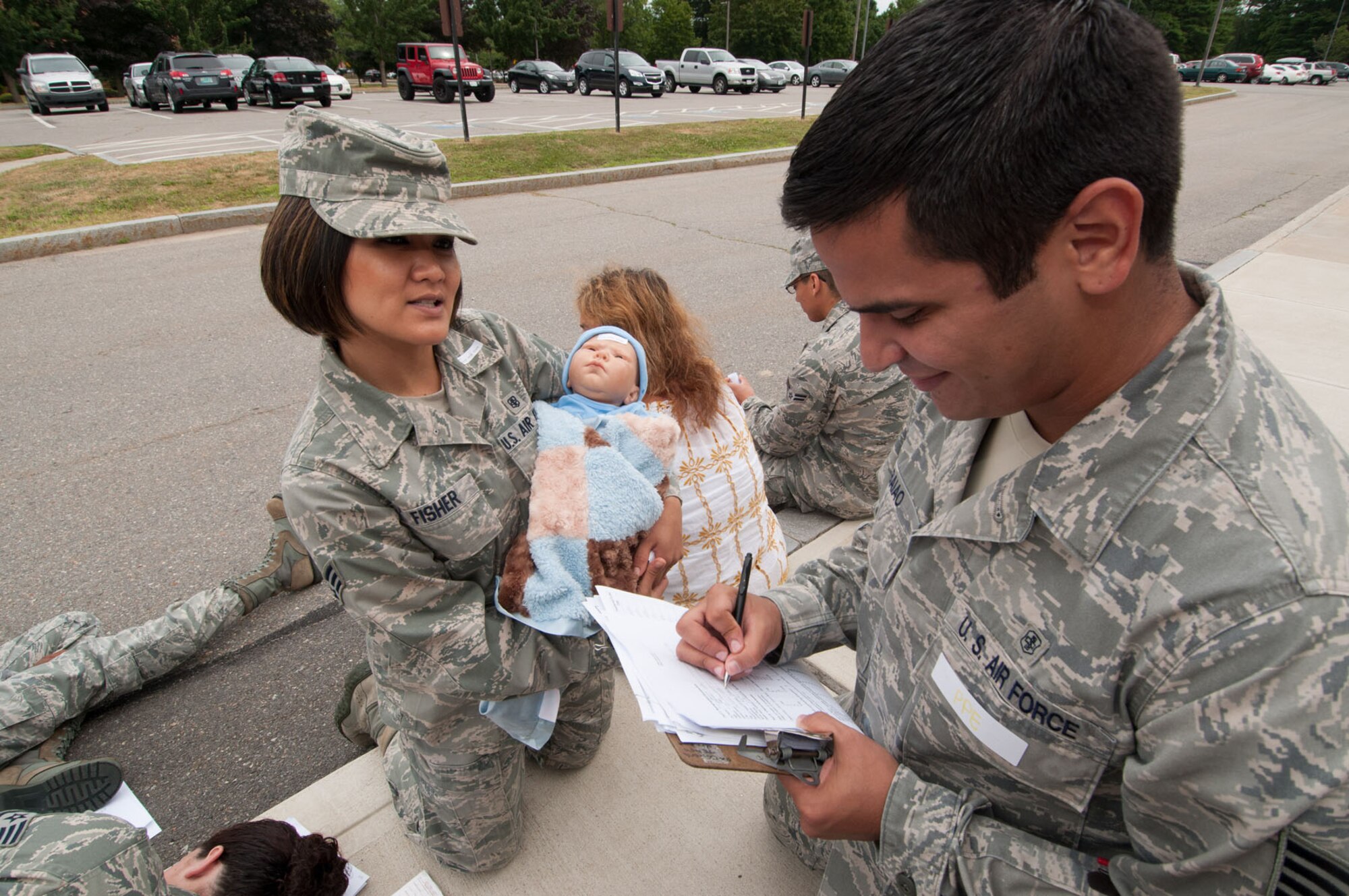 HANSCOM AIR FORCE BASE, Mass. – Senior Airman Joanna Fisher, an actor during the base readiness exercise, provides information to Staff Sgt. Phillip Baiao, 66th Medical Squadron, during the disease containment BRE July 20. The exercise scenario called for patients to show up at the clinic with symptoms of monkeypox and tested the clinic staff’s response. (U.S. Air Force photo by Rick Berry)