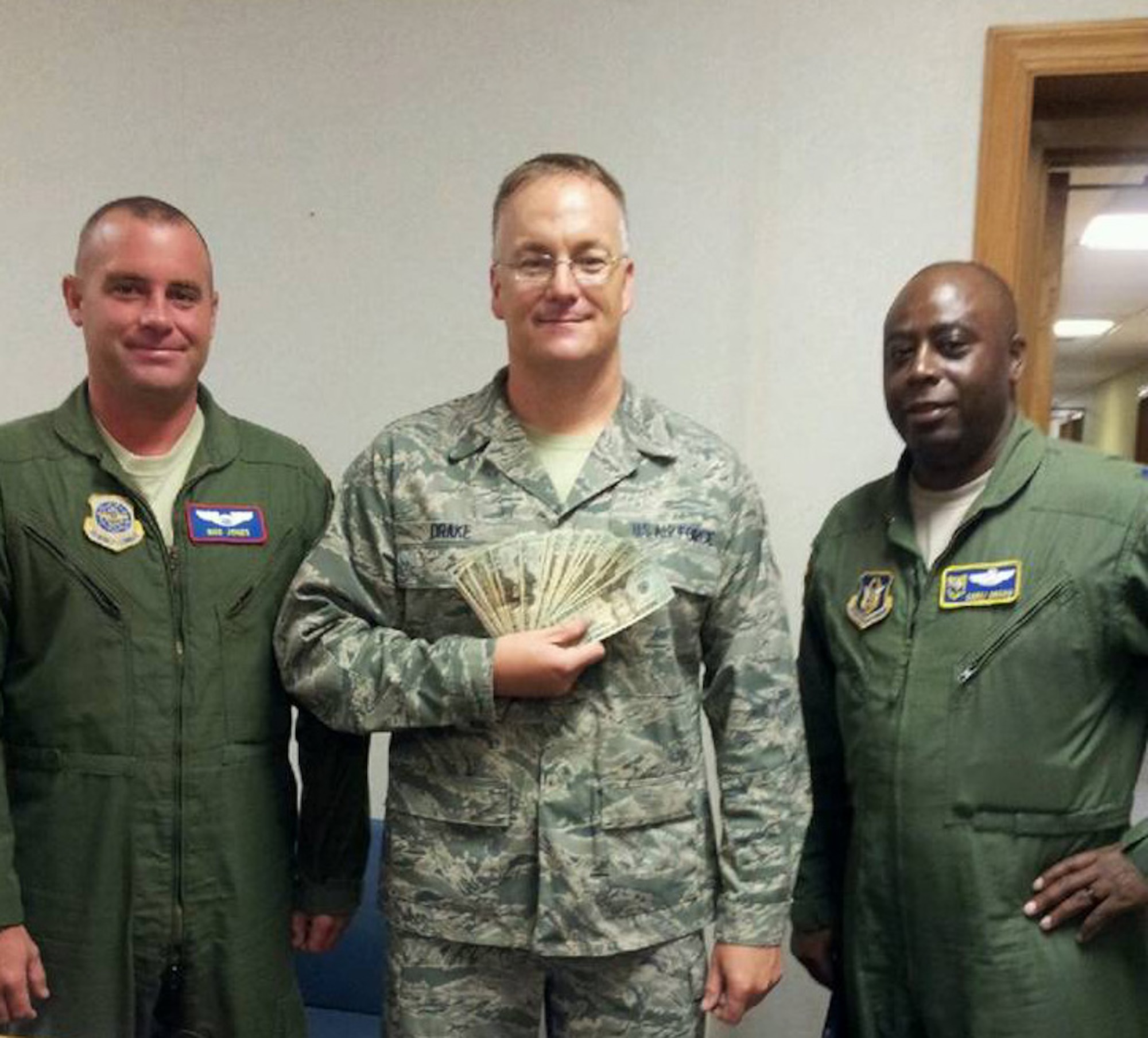 Capt. Clark Jones (left) and Lt. Col. Corey Brown (right) flank Staff Sgt. Dan Drake, who won the 916th's Biggest Loser Challenge in mid-July. (USAF photo by TSgt. Diane Speas, 916ARW/MSG)