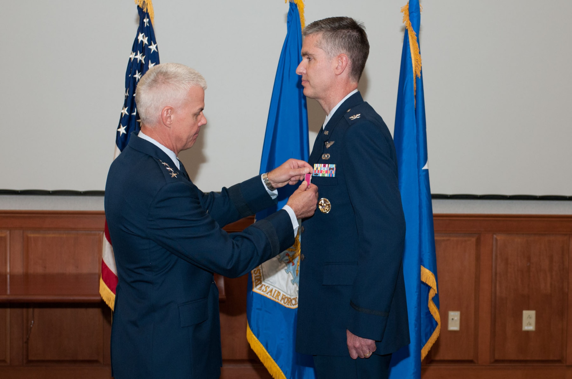 HANSCOM AIR FORCE BASE, Mass. – Lt. Gen. CR Davis, current military deputy for the Office of the Assistant Secretary of the Air Force for Acquisition and former Electronic Systems Center commander, pins the Legion of Merit on Col. Mark S. Spillman during his retirement ceremony in the Garden Auditorium July 19. Spillman served as ESC vice commander from June 2010 to May 2012 and as ESC commander from May 2012 until the organization’s transition to the Life Cycle Management Center July 16. (U.S. Air Force photo by Rick Berry)