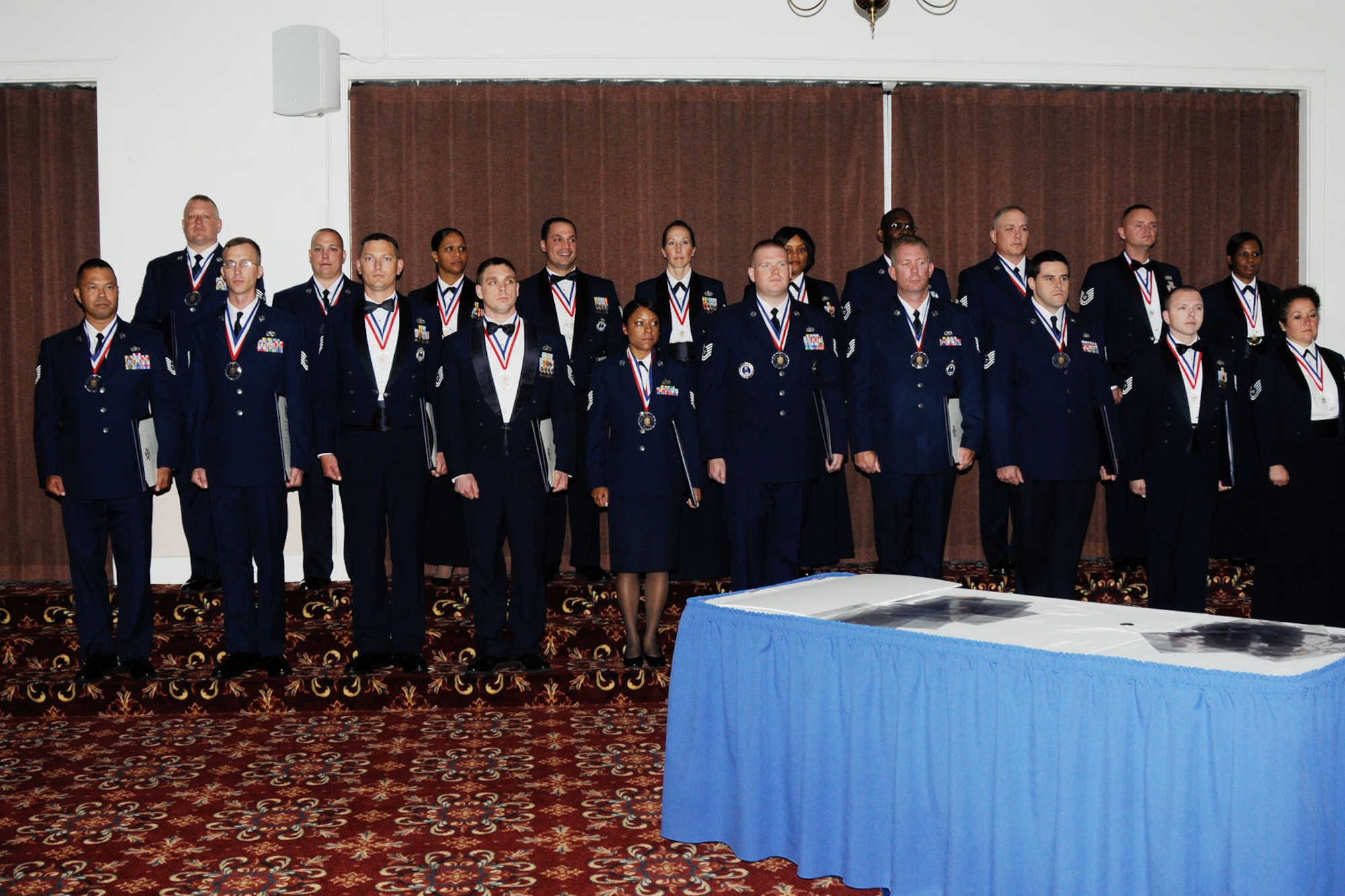 HANSCOM AIR FORCE BASE, Mass. – Twenty noncommissioned officers stand at attention just after “crossing the bridge,” symbolizing the transition from NCO to senior NCO, during the 2012 Senior Noncommissioned Officer Induction Ceremony at the Minuteman Commons July 20. The ceremony celebrated NCOs that made the rank of master sergeant. (U.S. Air Force photo by Linda LaBonte Britt)
