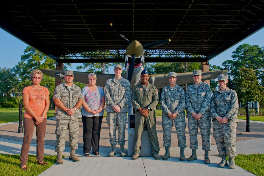 From left to right, Rhonda Olheiser, Master Sgt. Kevin Jenkins, Carol Meyer, Tech. Sgt. Alex Griffin, Lt. Col. Sean Monteiro, 1st Lt. Nora Saed, 2nd Lt. Katherine Higdon and 1st Lt. Chelsea Hendel, Open House Director’s Work Group members, pose for a photo July 25, 2012, at Moody Air Force Base, Ga. As Open House work group members, the team coordinates and plans open house courses of action to ensure the best possible show for the community when the gates open on Oct. 27. (U.S. Air Force photo by Staff Sgt. Jamal D. Sutter/Released)