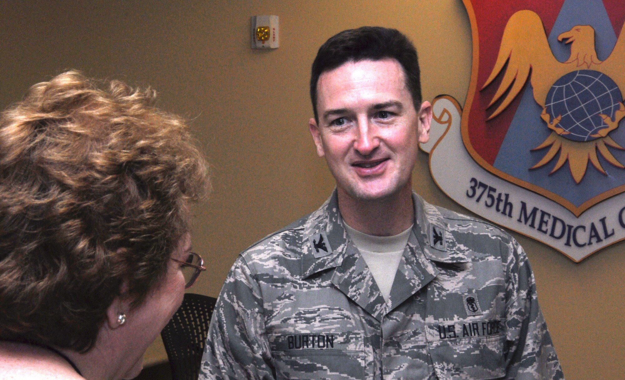 Col. Bret Burton speaks with a customer at the 375th Medical Group Clinic July 19, 2012. Burton assumed command of the organization July 6, 2012. (U.S. Air Force photo/Airman 1st Class Jake Eckhardt)