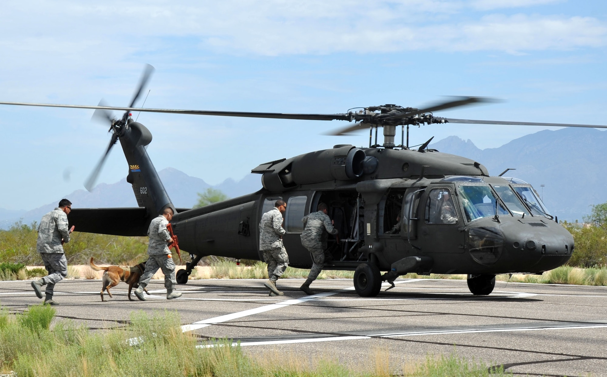 Students board an Arizona Army National Guard UH-60 Black Hawk helicopter during a training exercise that prepared them to safely manauver around helicopters in a deployed environment. Volunteer students from all brances of service stationed at Davis Monthan Air Force Base, Ariz. took part in the training exercise. (U.S. Air Force photo/ Master Sgt. Luke Johnson)