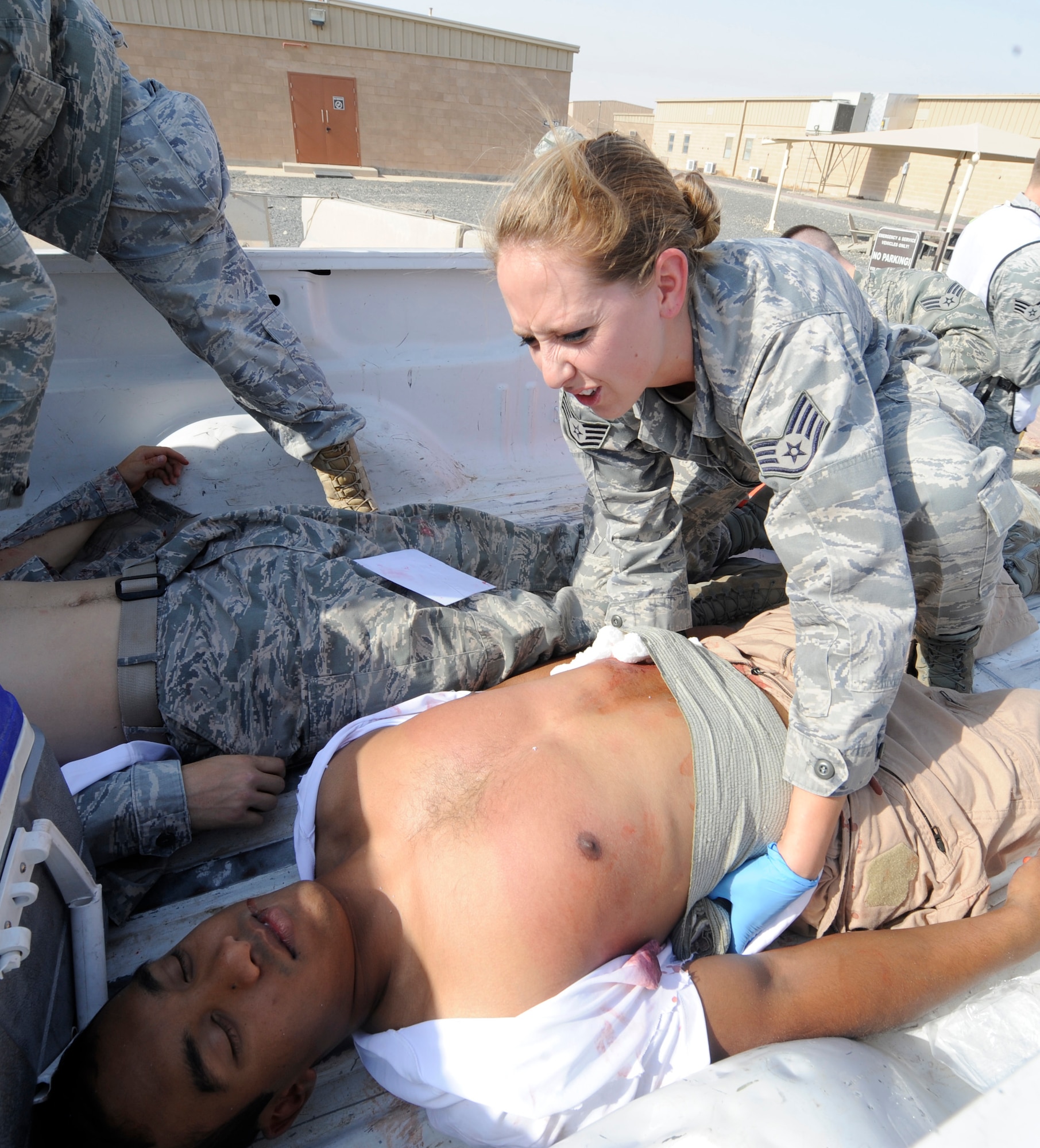 SOUTHWEST ASIA – Staff Sgt. Shila Bonin, 386th Expeditionary Medical Squadron, provides medical support on Jason David, Air Force Academy cadet and simulated victim, during an active shooter exercise here July 23. There were six simulated victims and two simulated active-shooters during this exercise. (U.S. Air Force photo/Staff Sgt. Alexandra M. Boutte)