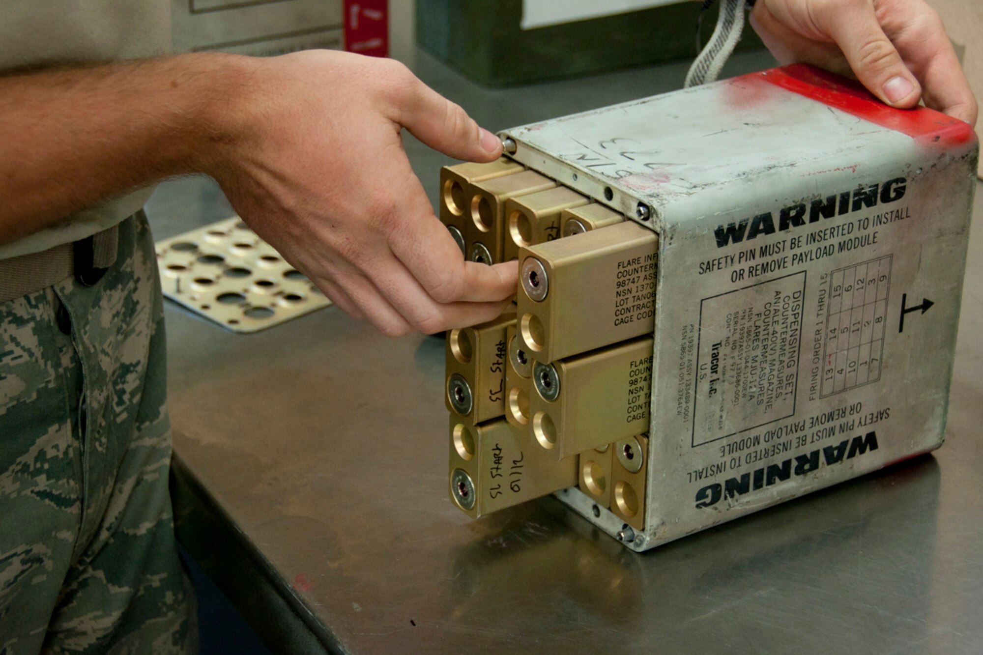 JOINT BASE PEARL HARBOR-HICKAM, Hawaii - Cartridges are loaded into a flare module by a member of the 917th Maintenance Squadron from Barksdale Air Force Base, La. during the Rim of the Pacific military exercise July 20, 2012, at Joint Base Pearl Harbor-Hickam, Hawaii. The module was bound for an A-10 Thunderbolt II from the 917th Fighter Group.  Twenty-two nations, more than 40 ships and submarines, more than 200 aircraft and 25,000 personnel are participating in RIMPAC exercise from June 29 to Aug. 3, in and around the Hawaiian Islands. The world's largest international maritime exercise, RIMPAC provides a unique training opportunity that helps participants foster and sustain the cooperative relationships that are critical to ensuring the safety of sea lanes and security on the world's oceans. RIMPAC 2012 is the 23rd exercise in the series that began in 1971. (U.S. Air Force photo by Staff Sgt. Ted Daigle)