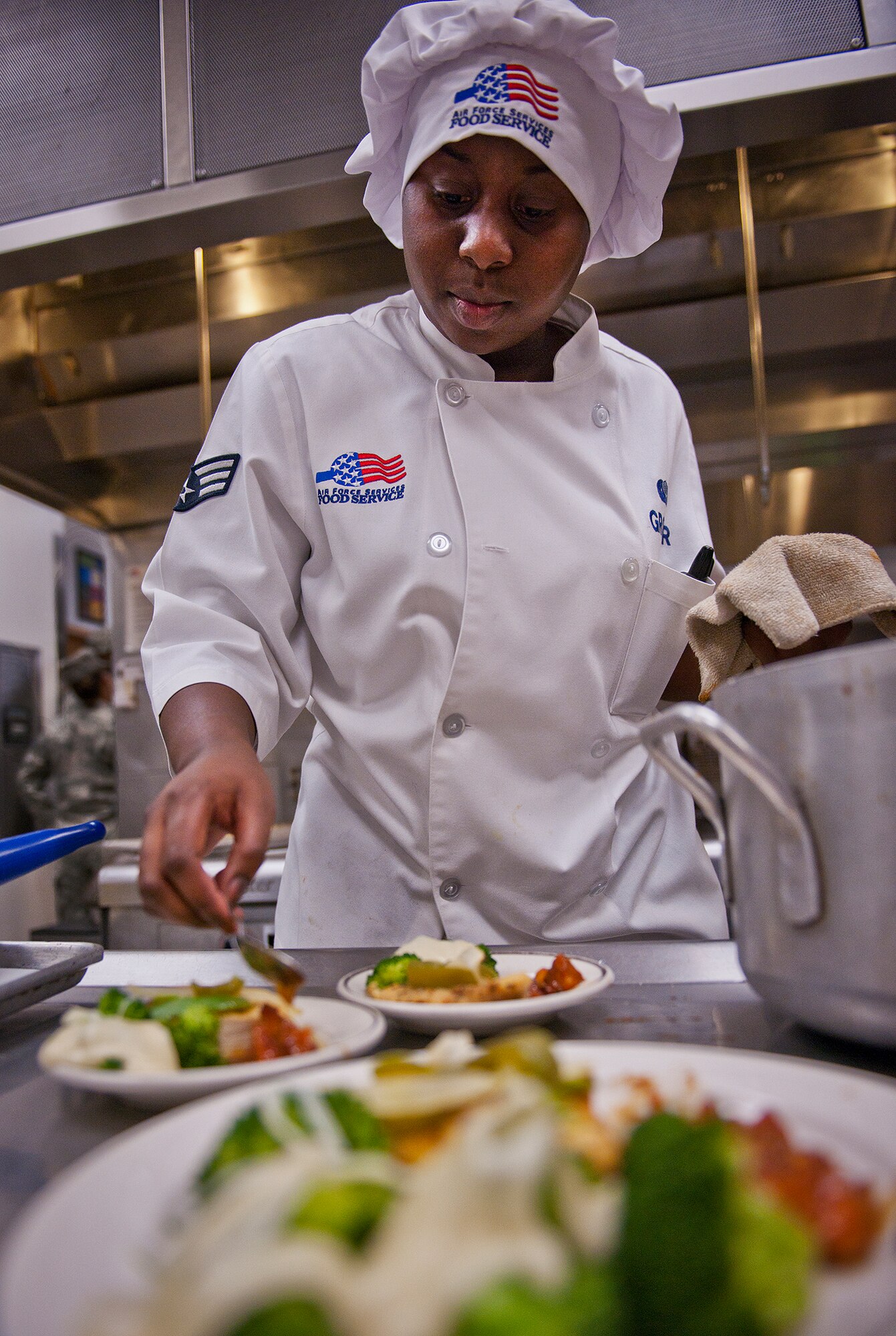 Senior Airman LaToya Grover places sweet potatoes on her plate during the base’s first “Chopped” cooking competition July 24 at Eglin.  Five Airmen from the 96th Force Support Squadron had an hour to cook a meal with three secret ingredients.  (U.S. Air Force photo/Samuel King Jr.)