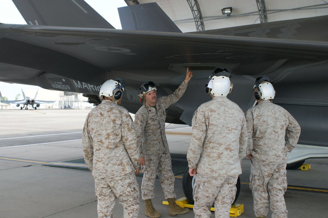Students learn about the F-35B Lightning II joint strike fighter's wing system from USMC Staff Sgt. Christopher Johnson (2nd from left) during training at Eglin Air Force Base, Fla., Jul. 19, 2012.  The USMC is standing up their first-ever field training detachment with the 372nd Training Squadron Detachment 19 at Eglin, part of the 982nd Training Group at Sheppard Air Force Base, Texas. (U.S. Air Force photo/Dan Hawkins)
