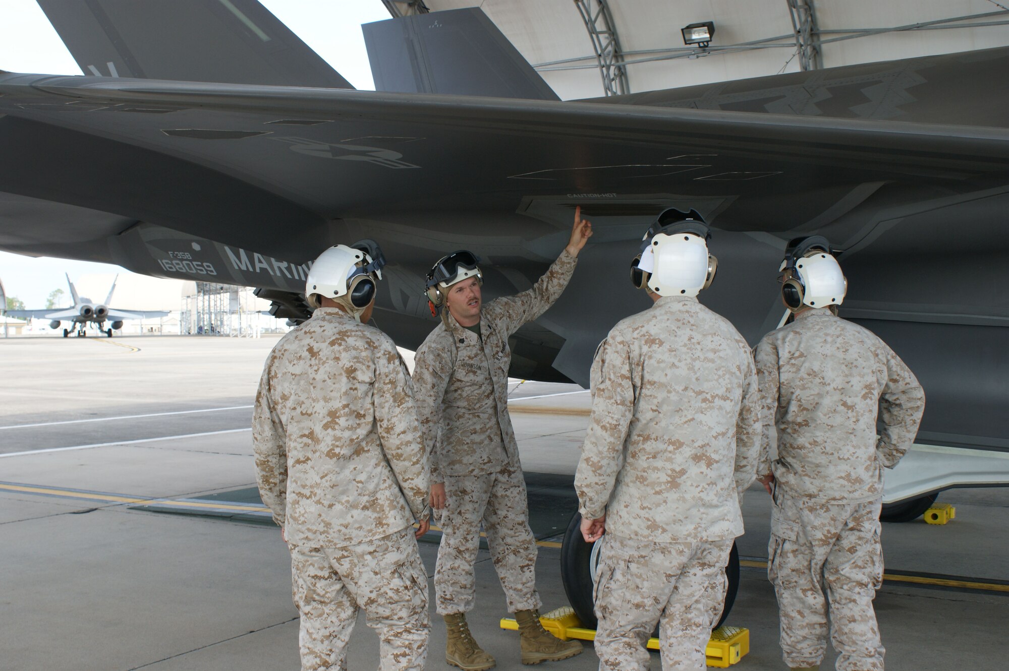 Students learn about the F-35B Lightning II joint strike fighter's wing system from USMC Staff Sgt. Christopher Johnson (2nd from left) during training at Eglin Air Force Base, Fla., Jul. 19, 2012.  The USMC is standing up their first-ever field training detachment with the 372nd Training Squadron Detachment 19 at Eglin, part of the 982nd Training Group at Sheppard Air Force Base, Texas. (U.S. Air Force photo/Dan Hawkins)