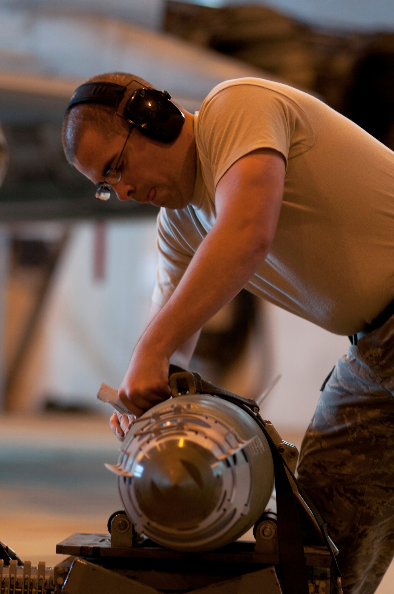 ROYAL AIR FORCE LAKENHEATH, England – Staff Sgt. Brandon Morefield, 494th Aircraft Maintenance Unit weapons load crew member, straps down a Guided Bomb Unit-38 munition during the Load Crew of the Quarter Competition July 20, 2012. The quarterly competition features the best load crew teams from the 492nd, 493rd and 494th Aircraft Maintenance Units. The winner is determined by the fastest time loading munitions with the least amount of errors. (U.S. Air Force photo by Airman 1st Class Cory D. Payne)