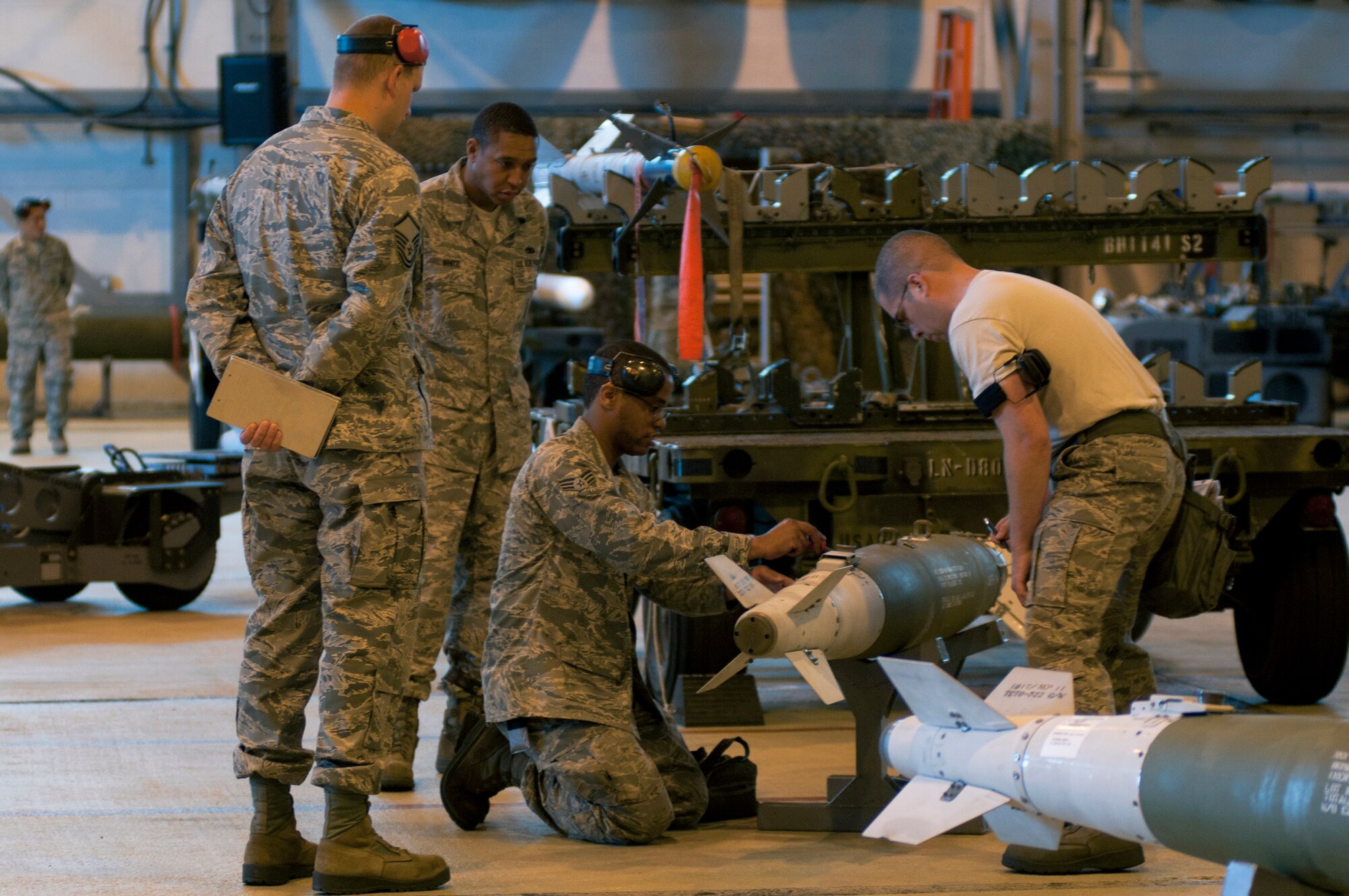 ROYAL AIR FORCE LAKENHEATH, England – The 494th Aircraft Maintenance Unit weapons load team prepares to load a Guided Bomb Unit-38 munition during the Load Crew of the Quarter Competition July 20, 2012. The quarterly competition features the best load crew teams from the 492nd, 493rd and 494th Aircraft Maintenance Units. The winner is determined by the fastest time loading munitions with the least amount of errors. (U.S. Air Force photo by Airman 1st Class Cory D. Payne)