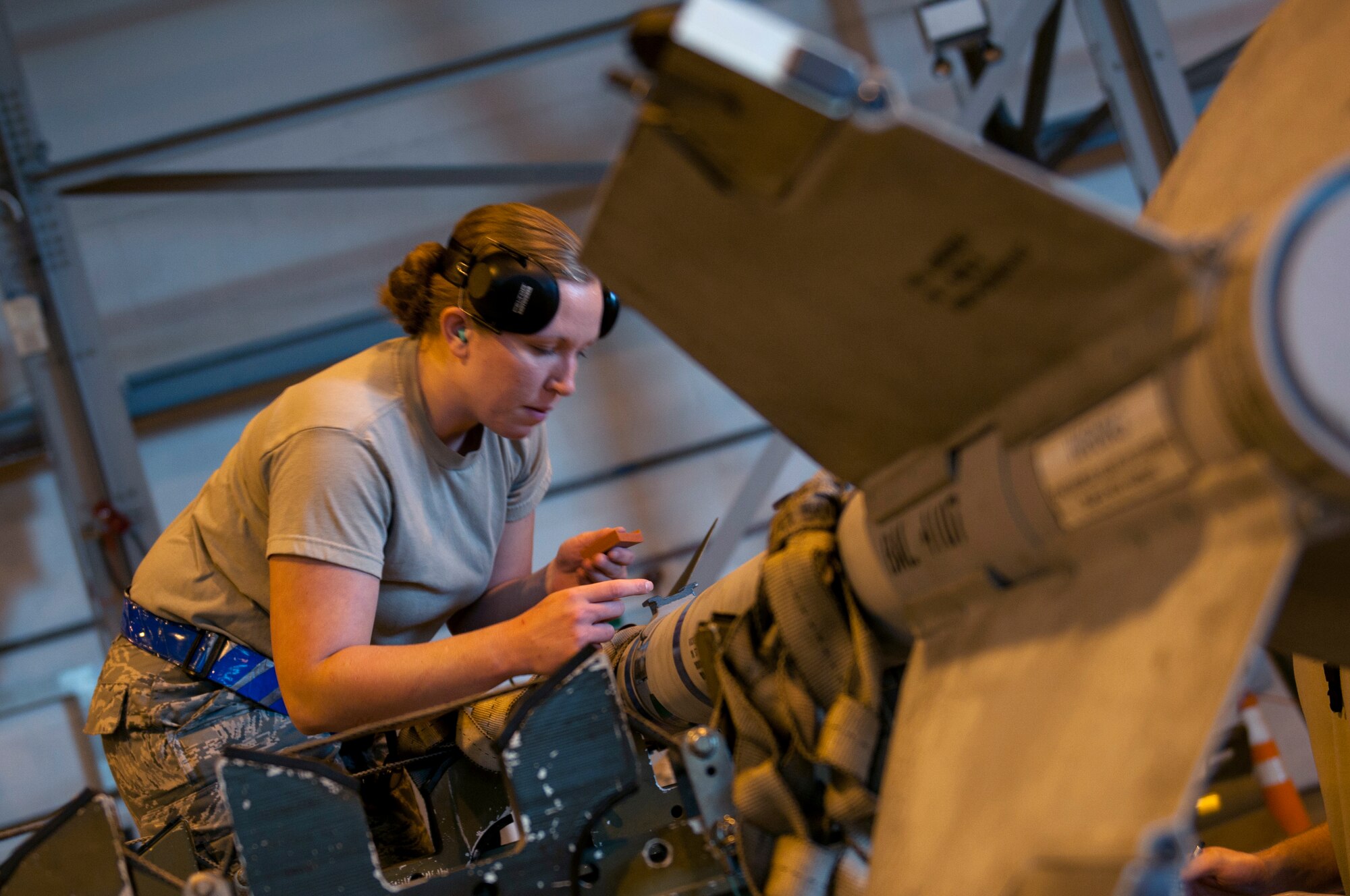 ROYAL AIR FORCE LAKENHEATH, England – Senior Airman Lori Morton, 492nd Aircraft Maintenance Unit load crew member, readies an Air Intercept Missle 9x munition for loading during the Load Crew of the Quarter Competition July 20, 2012. The quarterly competition features the best load crew teams from the 492nd, 493rd and 494th Aircraft Maintenance Units. The winner is determined by the fastest time loading munitions with the least amount of errors. (U.S. Air Force photo by Airman 1st Class Cory D. Payne)
