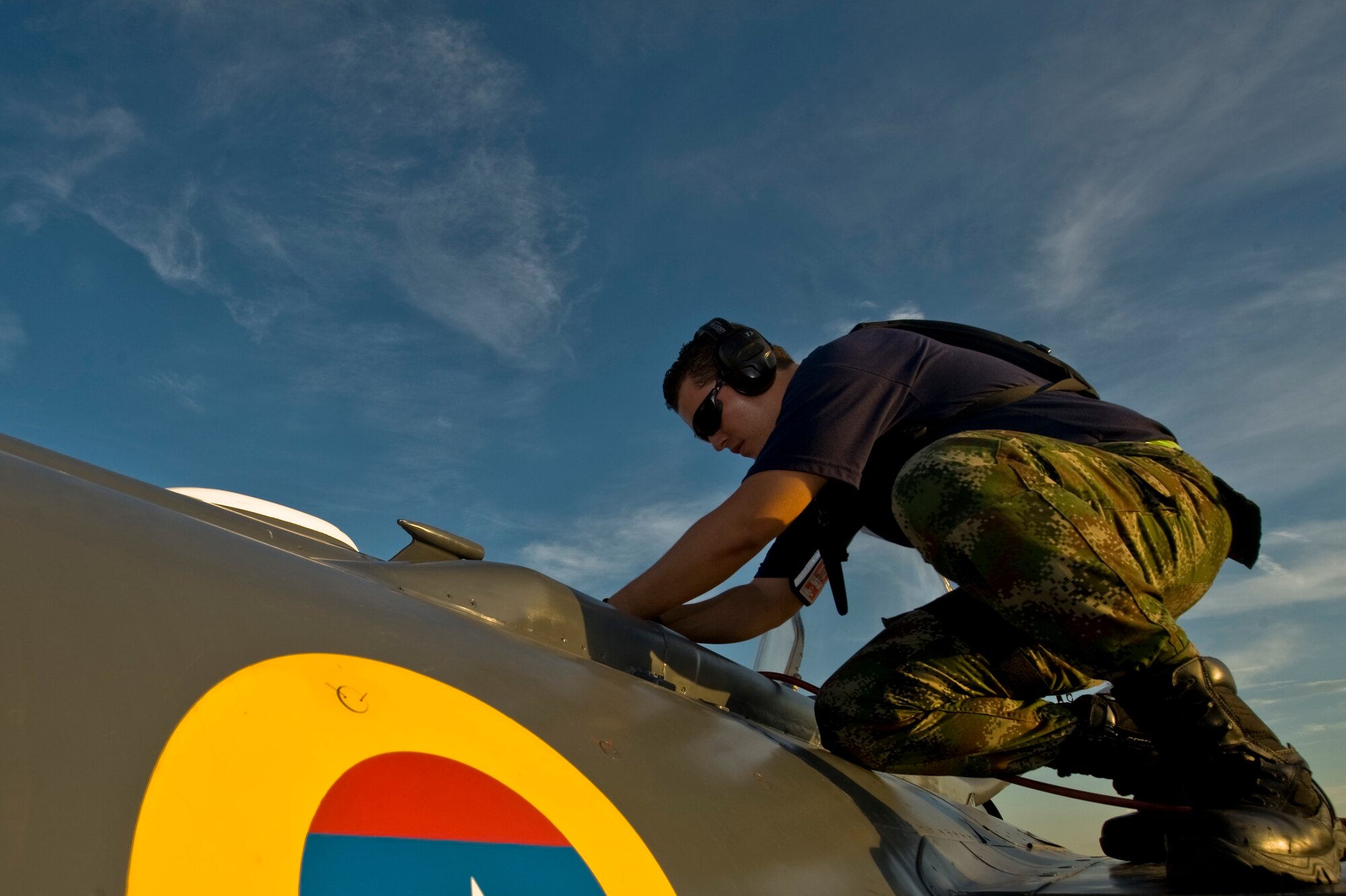 Colombian air force crew chief Suarez Miller prepares to drain a fuel tank on a Kfir during Red Flag 12-4 July 23, 2012, at Nellis Air Force Base, Nev. Miller works  to fix the problem to get the jet ready to rejoin the exercise. (U.S. Air Force photo by Airman 1st Class Daniel Hughes)