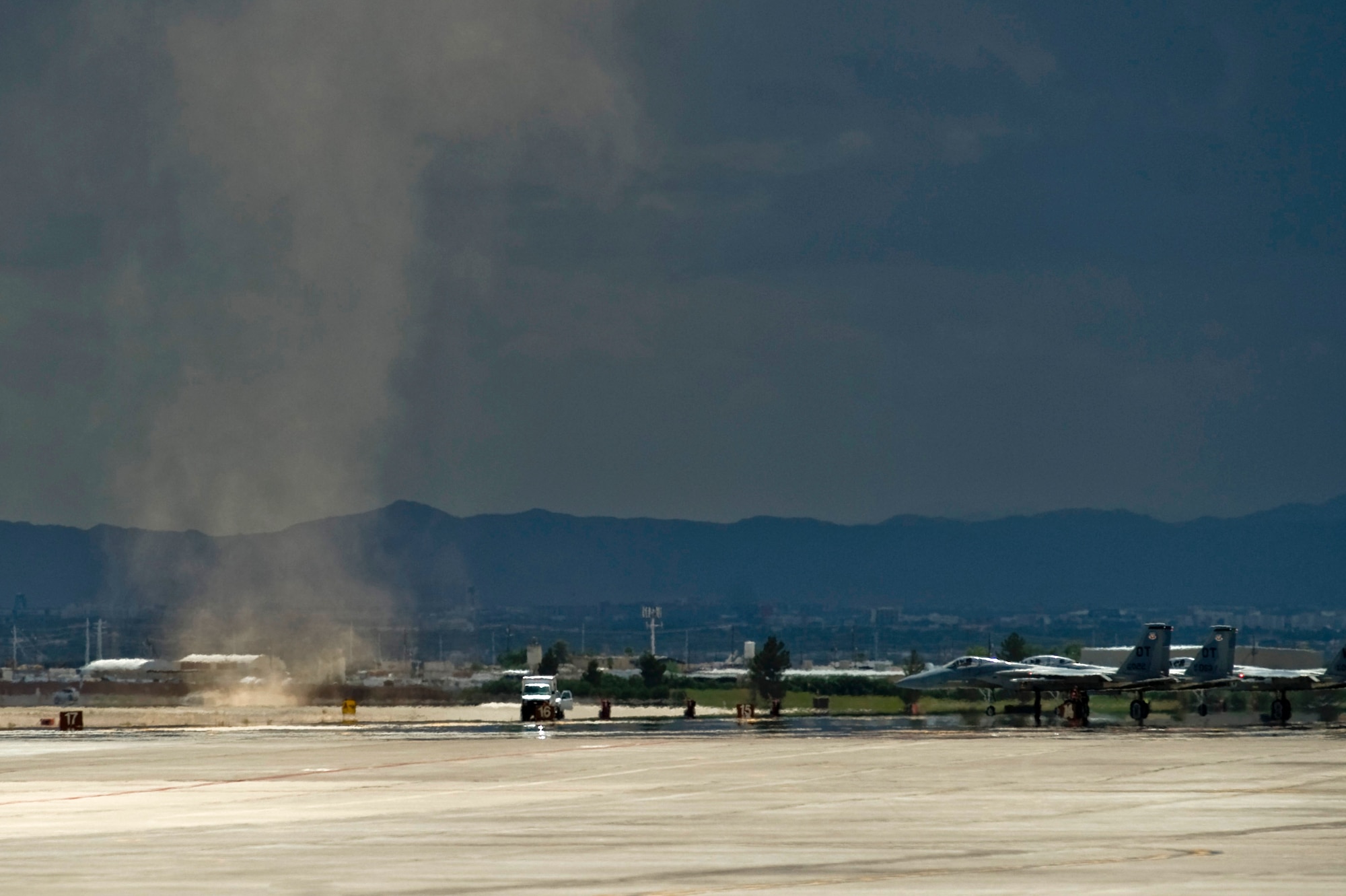 A dust devil whirls through the flight line just before the afternoon launch during Red Flag 12-4 July 23, 2012, at Nellis Air Force Base, Nev. The dust devil came when a thunderstorm moved across the Las Vegas valley and put the afternoon launch on a weather hold. (U.S. Air Force photo by Airman 1st Class Daniel Hughes)

