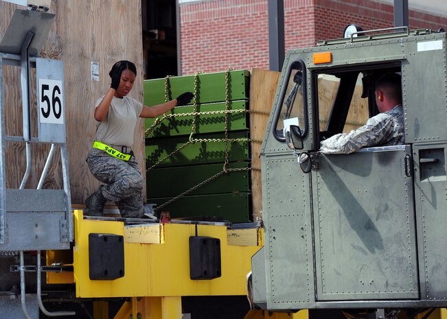 Airman 1st Class Tashanna Holt directs Senior Airman Kyle Greer, both 437th Aerial Port Squadron journeymen, July 17, 2012, at Joint Base Charleston – Air Base, S.C. The 60K-loader or Tunner, is named after Gen. William Tunner, who directed the Burma Hump, Korean and Berlin airlifts. The Tunner was engineered from the ground up as an entirely new system for loading and unloading aircraft and transporting loads. It has a loading capacity of 60,000 pounds and can hold up to six 463L pallets, which are used for transporting military air cargo. (U.S. Air Force photo/ Airman 1st Class Chacarra Walker)