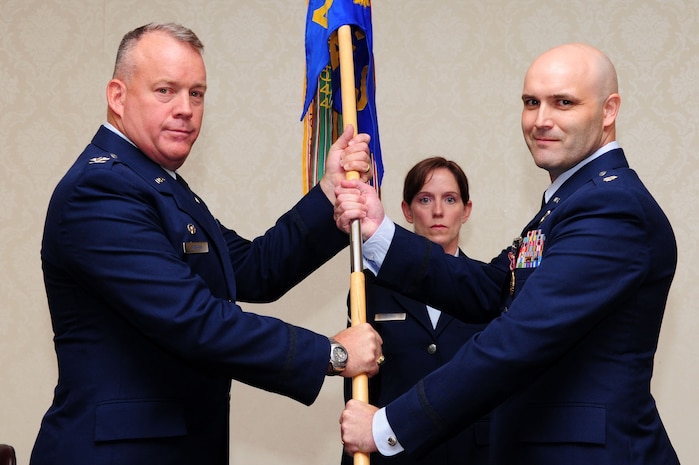 Colonel Erik Hansen, 437th Airlift Wing commander, receives the squadron guidon from Lt. Col. Todd Hohn, 16th Airlift Squadron, 437th AW outgoing commander, during the 16th AS Change of Command ceremony, July 23, 2012, at Joint Base Charleston - Air Base, S.C. The passing of the guidon symbolizes the changing of a command. (U.S. Air Force photo/ Airman 1st Class Chacarra Walker)