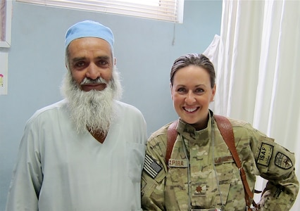 Major Courtney Schapira, 628th Medical Group dentist, poses for a photograph with Sayad Dost-M Amiri, Paktia Regional Military Hospital dental clinic chief, in Gardez, Afghanistan sometime during her deployment from November 2011 until May 2012. Schapira was the first, and only, Air Force dental advisor in Afghanistan. (Courtesy photo)