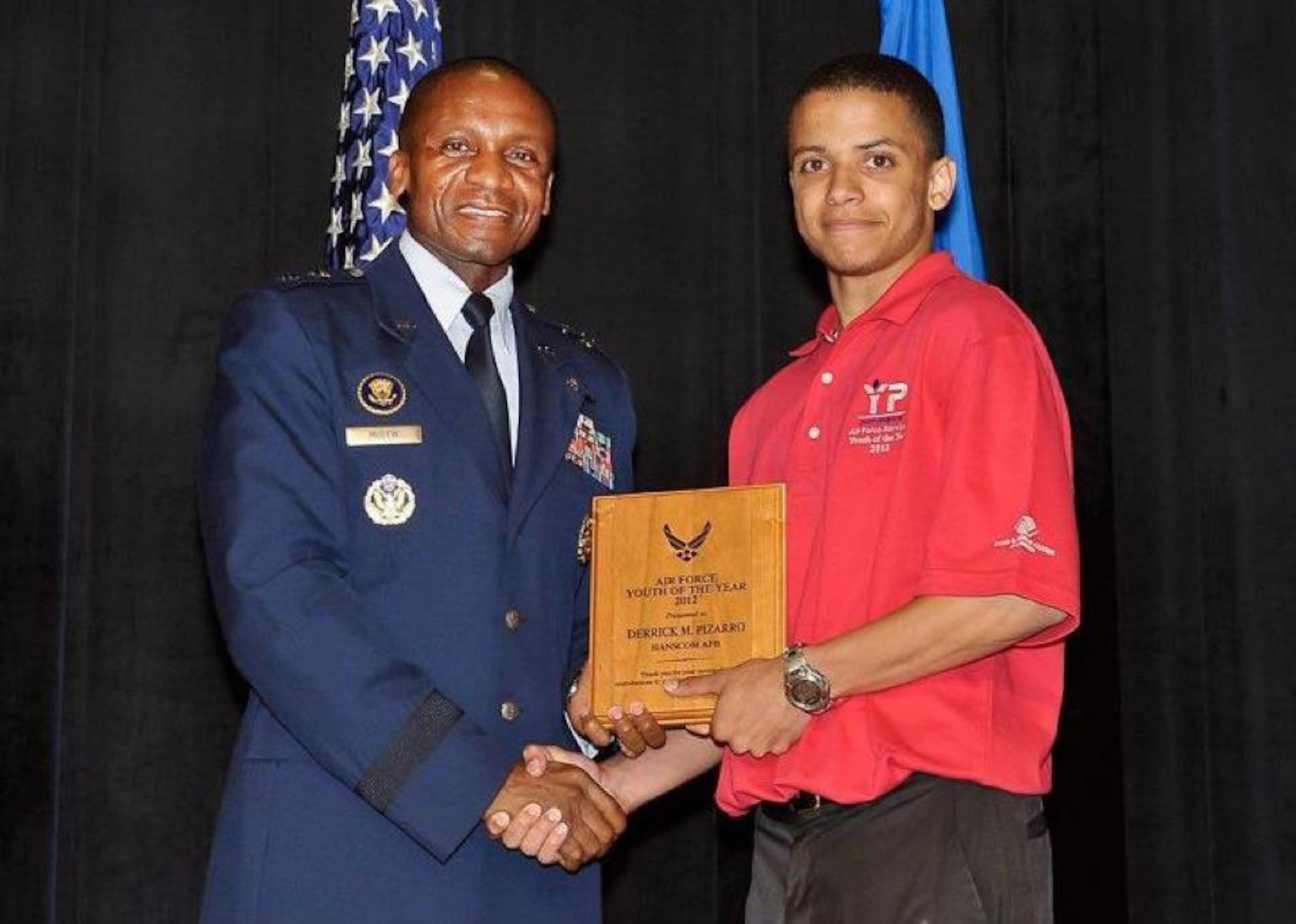Derrick Pizarro, Hanscom Youth of the Year, receives a plaque from Maj. Gen. Darren McDew, Air Force District of Washington commander, during the Air Force Youth of the Year awards ceremony in June at the Pentagon. Being named Youth of the Year is the highest honor a Boys & Girls Club member can receive. (Courtesy photo)