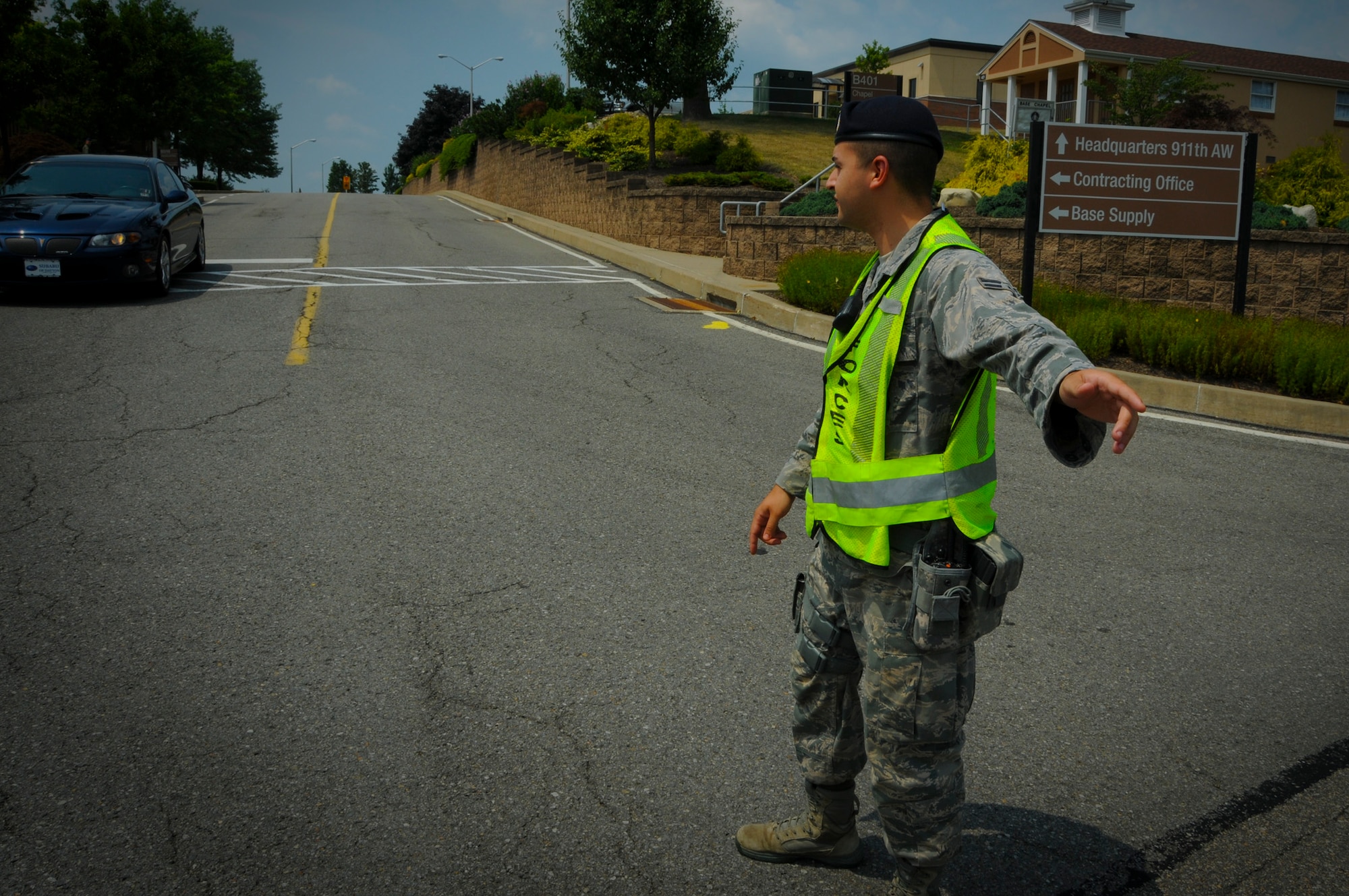 Airman 1st Class Hector Montanez, 911th Security Forces Squadron patrolman, safely directs traffic at the intersection of Defense Avenue and Brown Street, here, July 18, 2012. Security Forces patrolmen are responsible for base security, guiding and directing traffic, safety of all members and visitors of the base, and base resources. Patrolmen must also protect restricted areas and check for alarms as well as ensuring doors to all buildings are secure after business hours. (U.S. Air Force photo by Senior Airman Joshua J. Seybert/Released)