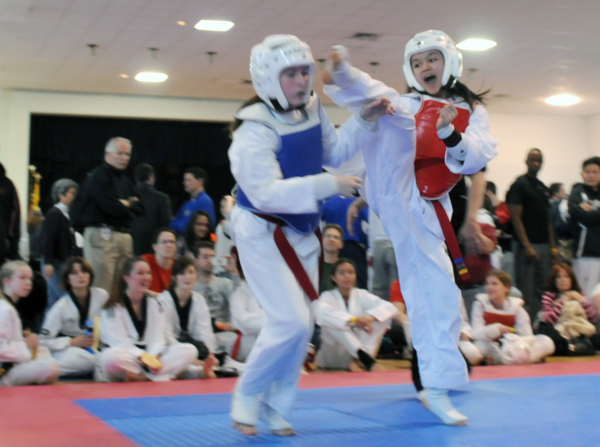 Madisyn Puangco, right, a Taekwondo student, kicks an opponent during the USA Taekwondo National Qualifier Feb. 9, 2012, in Dallas. Puangco placed first at the USA Taekwondo National Qualifier. (U.S. Air Force photo by Airman 1st Class Samuel Taylor)
