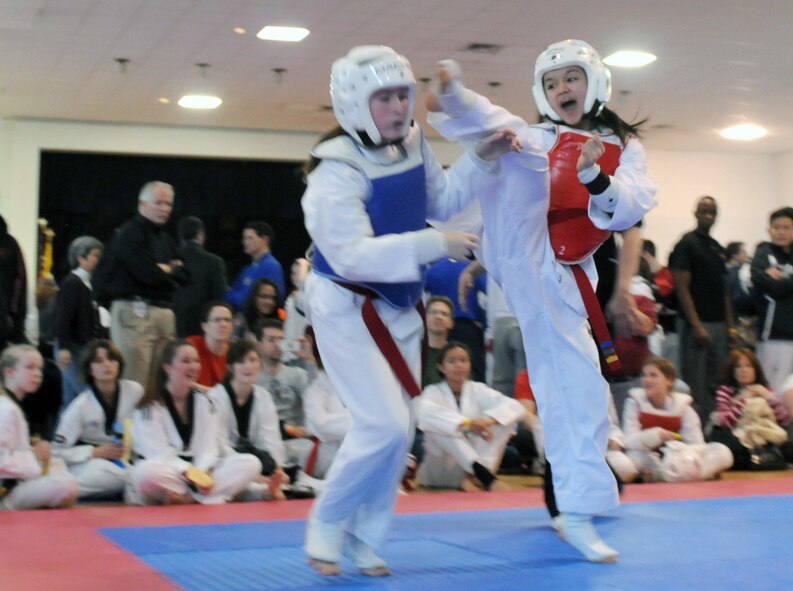 Madisyn Puangco, right, a Taekwondo student, kicks an opponent during the USA Taekwondo National Qualifier Feb. 9, 2012, in Dallas. Puangco placed first at the USA Taekwondo National Qualifier. (U.S. Air Force photo by Airman 1st Class Samuel Taylor)
