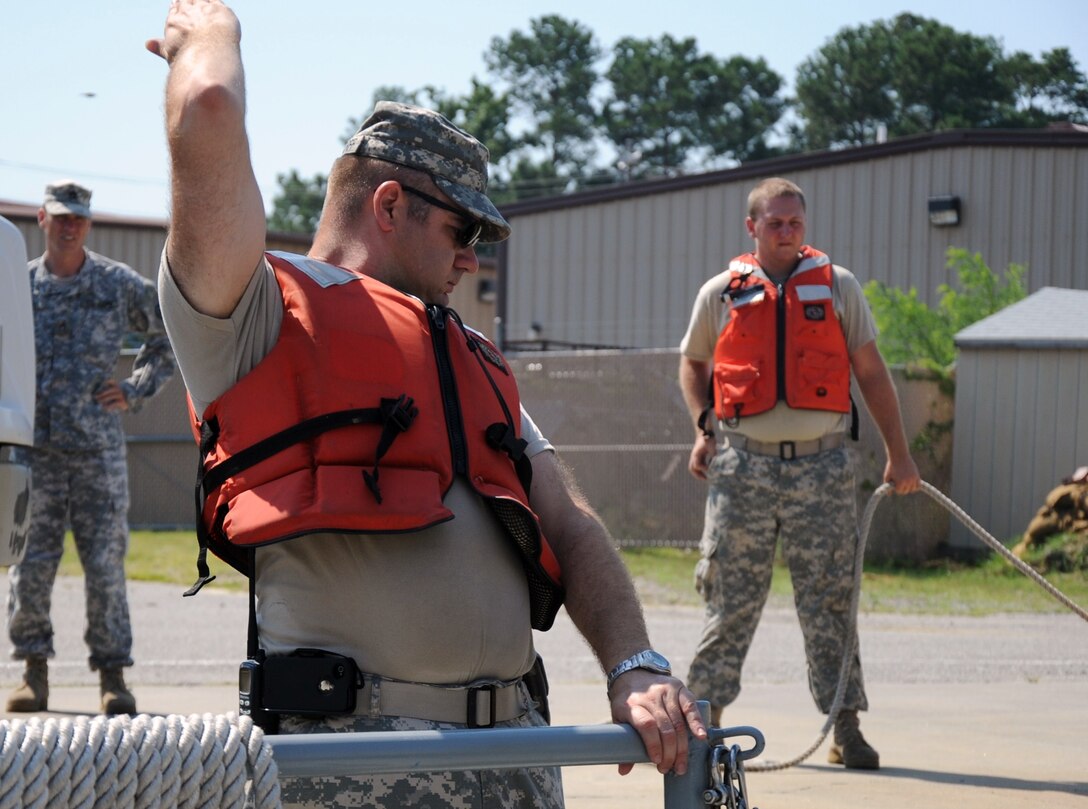 U.S. Army Sgt. Christopher Mortorff, 464th Transportation Company vessel master from Fort Belvoir, Va., provides hand signals to his crew during Operation Dragon Wave at Fort Eustis, Va., July 24, 2012. During the exercise, more than 200 reservists provided Logistics-Over-the-Shore support to the fictitious Combined Joint Task Force Sumatra. (U.S. Air Force photo by Senior Airman Jason J.
Brown/Released)
