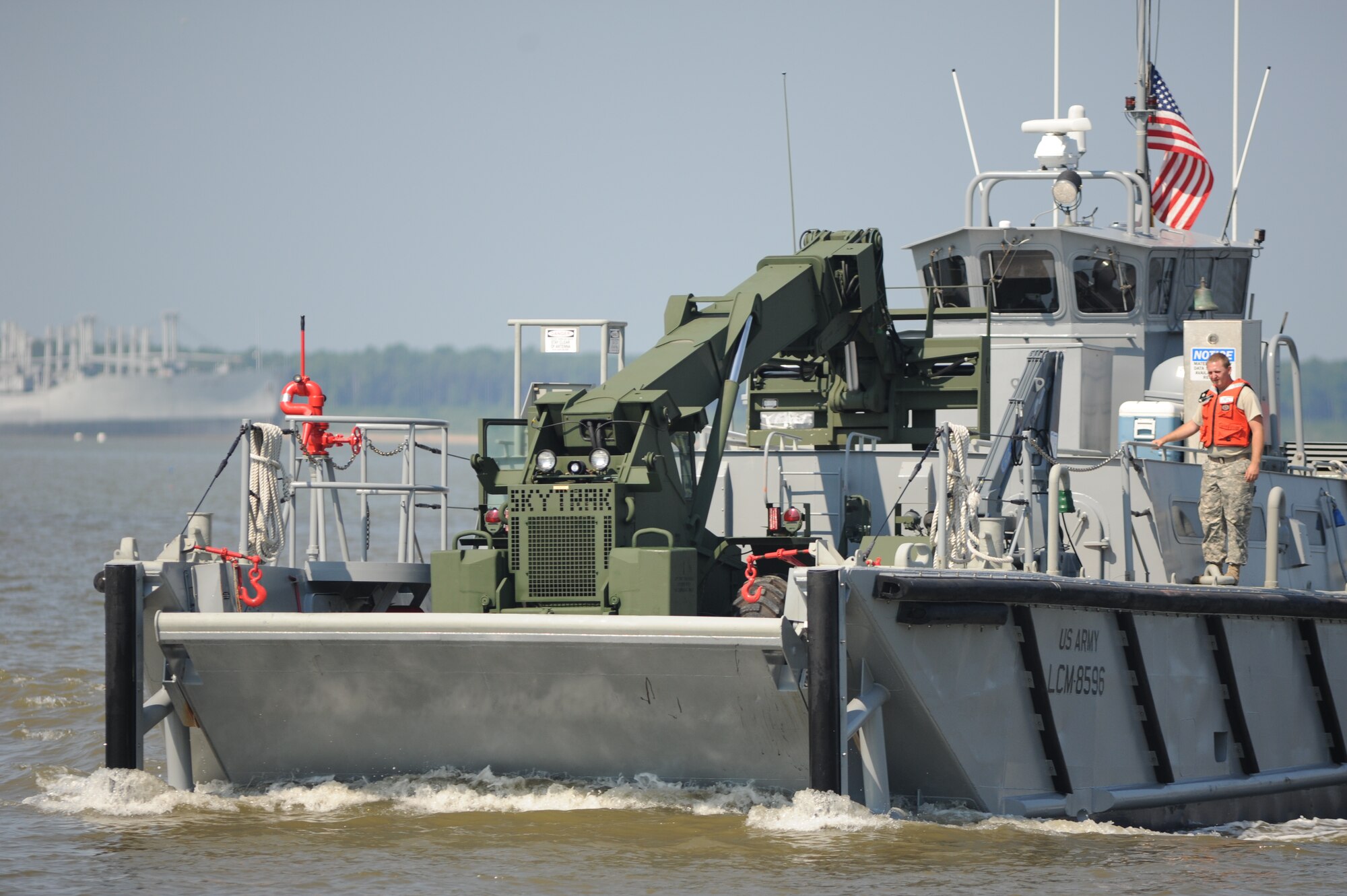 The U.S. Army Reserve's LCM-8596, a landing craft mechanized, or "Mike" boat, powers along the James River toward Utah Beach during Operation Dragon Wave at Fort Eustis, Va., July 24, 2012. The vessels carried cargo, including vehicles, pallets and equipment, from shore-to-shore to test the 359th Transportation Battalion's ability to execute Logistics-Over-the-Shore operations. (U.S. Air Force photo by Senior Airman Jason J. Brown/Released)