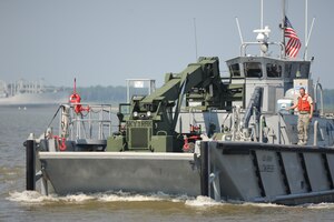 The U.S. Army Reserve's LCM-8596, a landing craft mechanized, or "Mike" boat, powers along the James River toward Utah Beach during Operation Dragon Wave at Fort Eustis, Va., July 24, 2012. The vessels carried cargo, including vehicles, pallets and equipment, from shore-to-shore to test the 359th Transportation Battalion's ability to execute Logistics-Over-the-Shore operations. (U.S. Air Force photo by Senior Airman Jason J. Brown/Released)