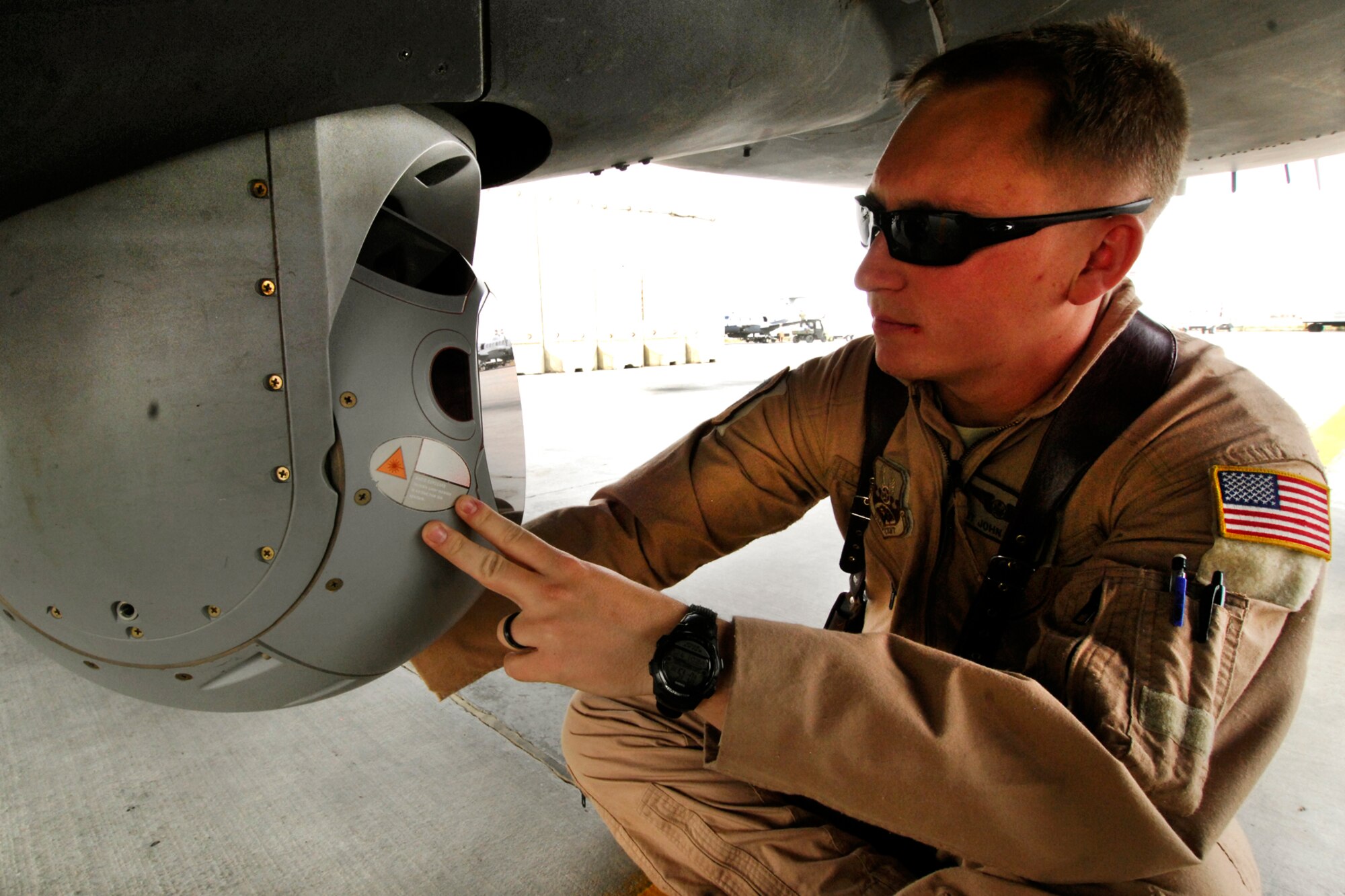 SSgt. John Busbee, 4th Expeditionary Reconnaissance Squadron sensor operator inspects a sensor on an MC-12 Liberty before a flight at Bagram Airfield, Afghanistan, July 25, 2012. Before each mission, the maintenance crew and a sensor operator ensures that the sensor is clean and operational. (U.S. Air Force photo/SSgt Jeff Nevison)