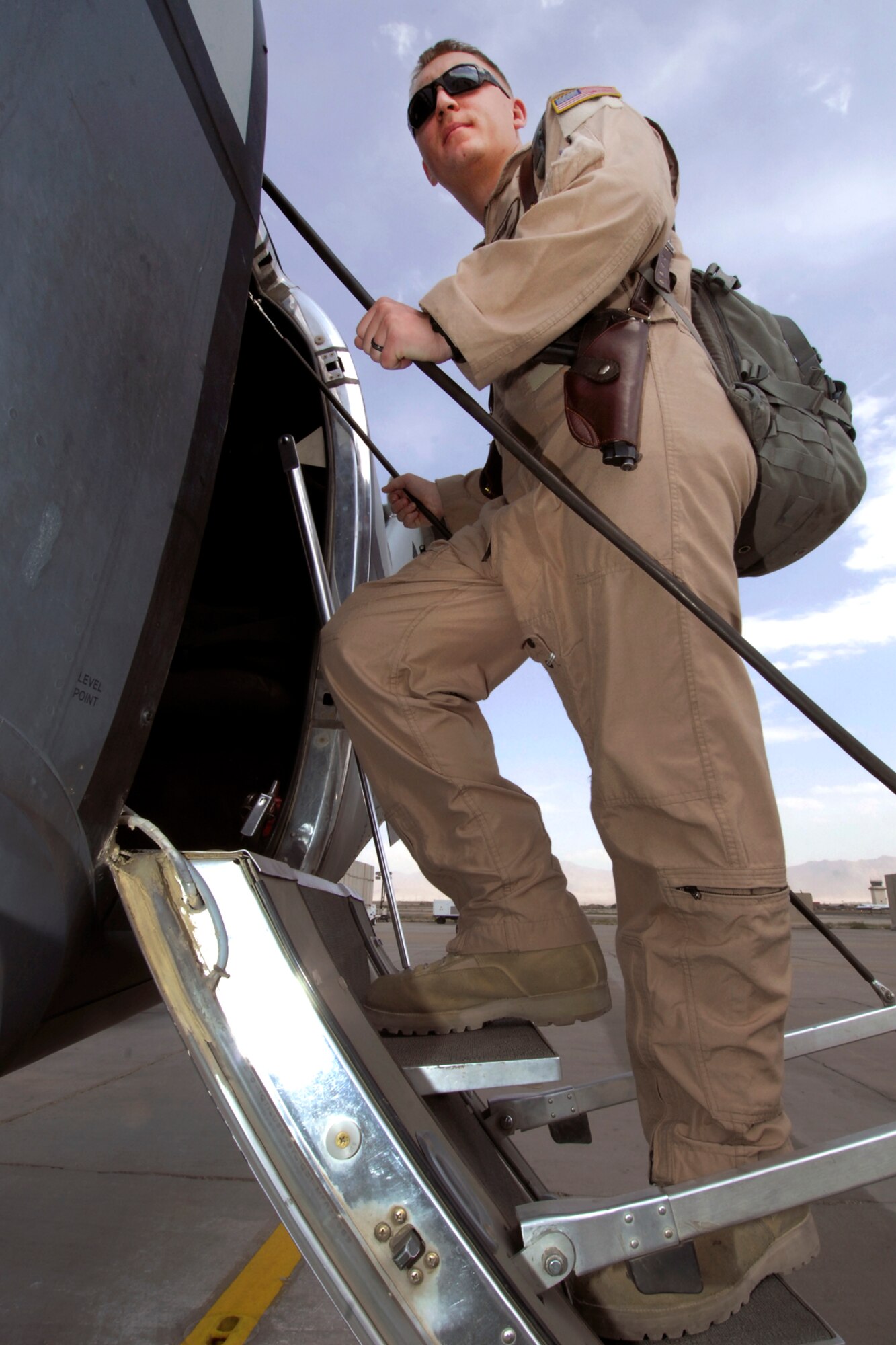 SSgt. John Busbee, 4th Expeditionary Reconnaissance Squadron sensor operator, boards an MC-12 for a mission at Bagram Airfield, Afghanistan, July 25, 2012. This is Busbee’s third deployment and first time assigned to a reconnaissance mission. (U.S. Air Force photo/SSgt Jeff Nevison)