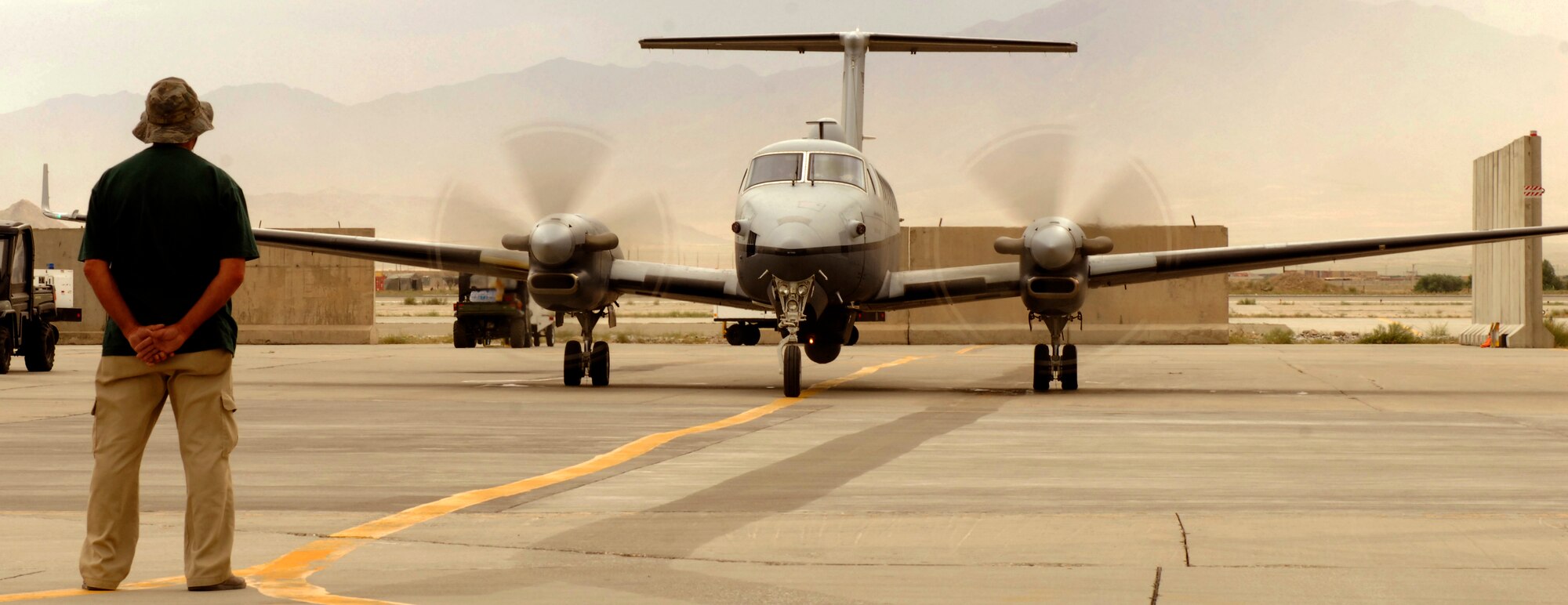 Roger Whitener, 4th Expeditionary Reconnaissance Squadron MC-12 Airframe mechanic from Augusta, Georgia marshals an MC-12 Liberty at Bagram Airfield, Afghanistan, June 28, 2012. The MC-12s are currently the most tasked manned airframe in the Air Force and have the highest operations tempo as far as dwell ratios go. (U.S. Air Force photo/Staff Sgt. Jeff Nevison)