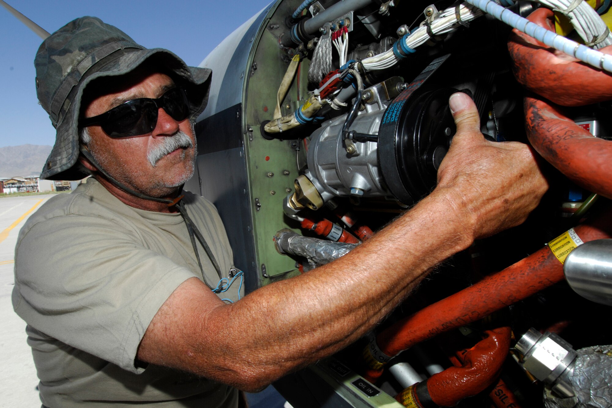 Roger Whitener, 4th Expeditionary Reconnaissance Squadron MC-12 Airframe mechanic from Augusta, Georgia, inspects the engine and air compressor of an MC-12 after landing to make sure safety mechanisms are in place and in working order. The MC-12 mechanics inspect each aircraft after they land so that they’re prepared for the next flight. (U.S. Air Force photo/Staff Sgt. Jeff Nevison)