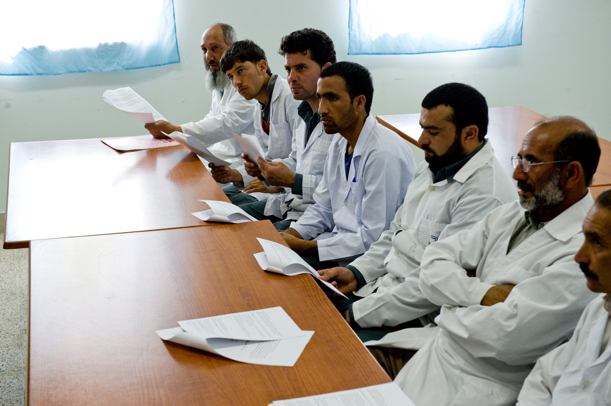 A group of Afghan doctors review the first official food safety directive for the country, Herat, Afghanistan, July 15, 2012. The food safety directive gives a baseline to the Afghan military so they are able to perform inspections on food facilities. (U.S. Air Force photo by Staff Sgt. Greg C. Biondo)(Released)