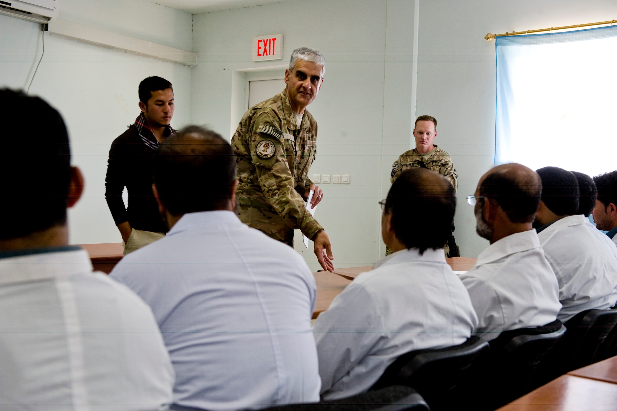 U.S. Air Force Maj. Jose Diaz, a preventive medicine mentor with the Joint Medical Operations Cell, talks to a group of Afghan doctors about the first official food safety directive for the country, Herat, Afghanistan, July 15, 2012. The food safety directive gives a baseline to the Afghan military so they are able to perform inspections on food facilities. (U.S. Air Force photo by Staff Sgt. Greg C. Biondo)(Released)