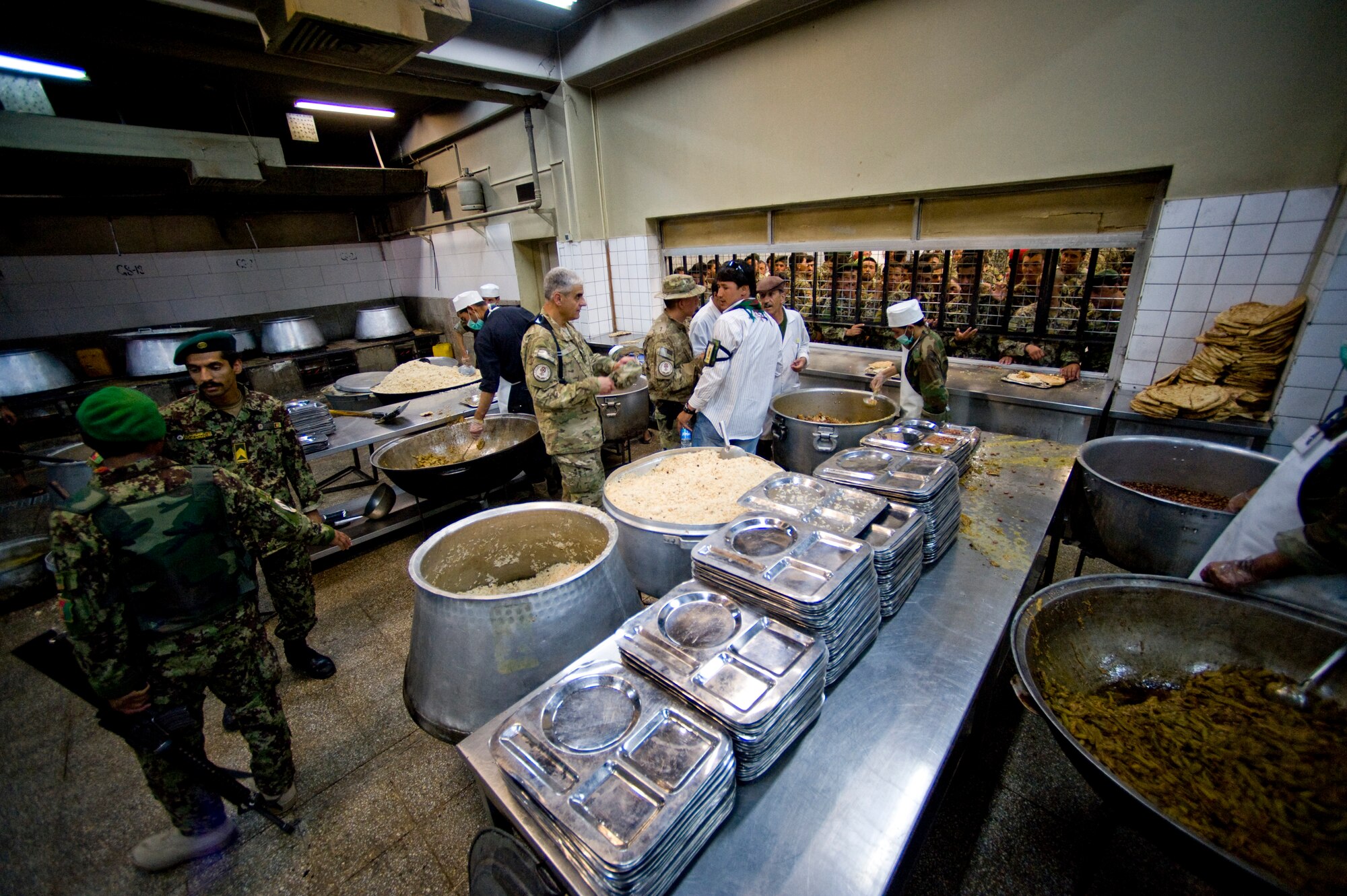 U.S. Air Force Maj. Jose Diaz and Staff Sgt. Anthony Rios, preventive medicine mentors with the Joint Medical Operations Center, inspect an Afghan military dining facility, Camp Stone, Afghanistan, July 14, 2012. The JMOC assists Afghans in developing a sustainable medical support system. (U.S. Air Force photo by Staff Sgt. Greg C. Biondo)(Released)