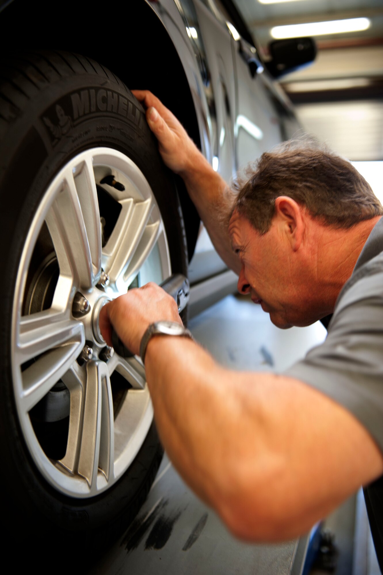 SPANGDAHLEM AIR BASE, Germany – Richard Winkelmann, 52nd Logistics Readiness Squadron privately owned vehicle inspector, verifies the size of a tire inside the privately owned vehicle inspection building here July 24.  Last year, the vehicle inspection office processed approximately 8,100 personal vehicles.  A thorough inspection must be done annually for vehicles six years or older, or every two years for newly purchased vehicles. (U.S. Air Force photo by Airman 1st Class Gustavo Castillo/Released)