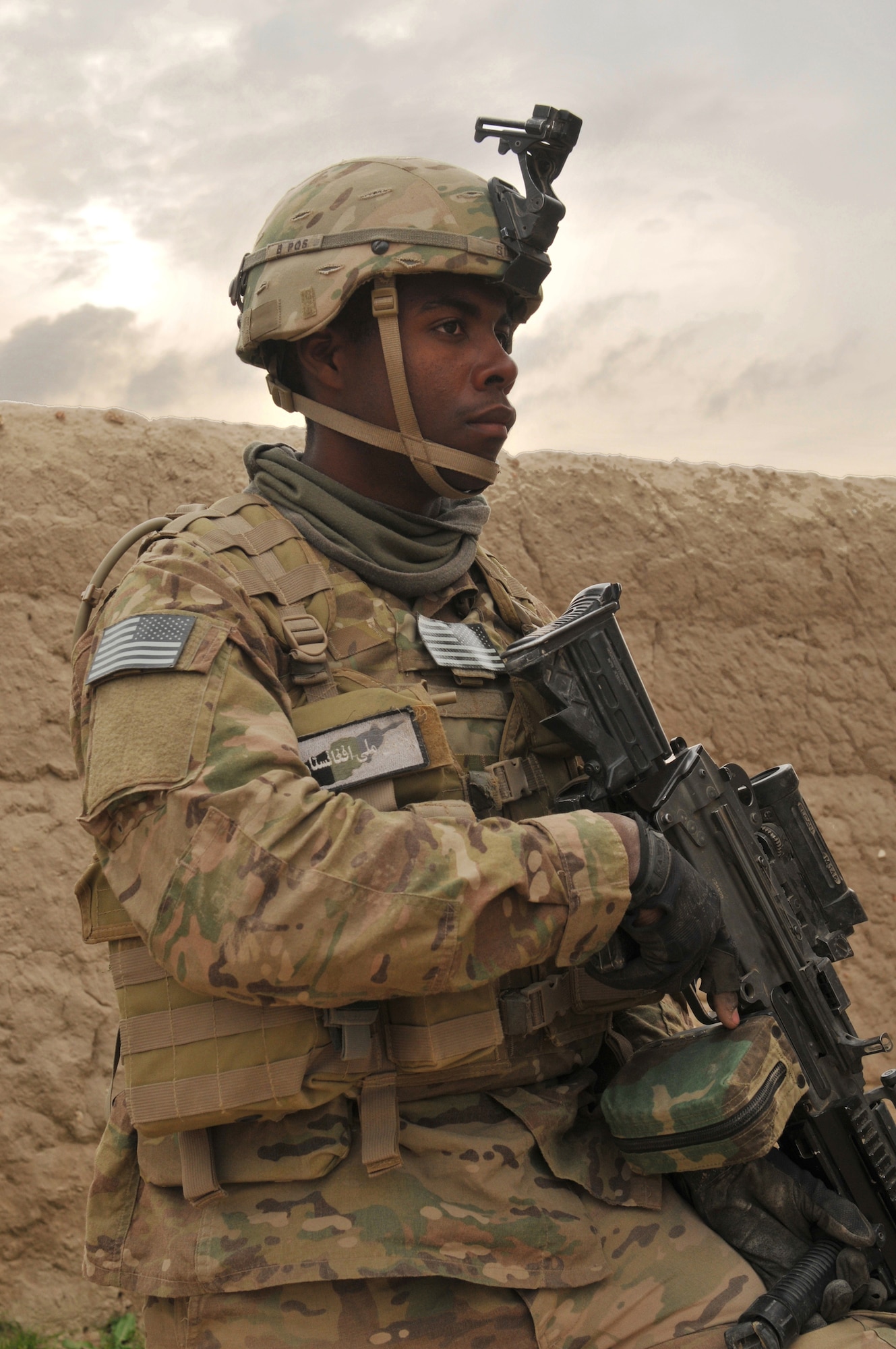 BALA MURGHAB, Afghanistan – Spc. Dwayne Simms-Sparks, a Red Platoon, Bulldog Troop forward observer with the 7th Squadron, 10th Cavalry Regiment, scans the horizon as members of his platoon speak with village elders in Kamisari Village, Bala Murghab District, Badghis Province, Afghanistan, April 4, 2011. Fifteen soldiers performed select-leader engagements in Kamisari during Operation Red Sand. (U.S. Air Force photo/Master Sgt. Kevin Wallace)