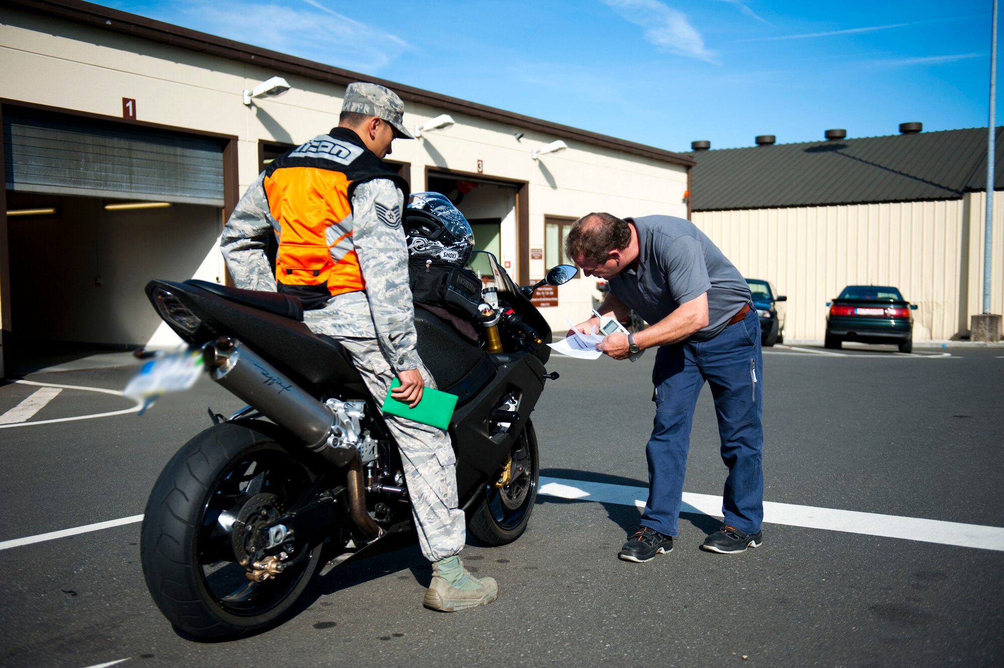 SPANGDAHLEM AIR BASE, Germany – Richard Winkelmann, 52nd Logistics Readiness Squadron privately owned vehicle inspector, inspects the blinkers of a motorcycle at the privately owned vehicle inspection building here July 24.  Last year, the vehicle inspection office processed approximately 8,100 personal vehicles.  A thorough inspection must be done annually for vehicles six years or older, or every two years for newly purchased vehicles. (U.S. Air Force photo by Airman 1st Class Gustavo Castillo/Released)