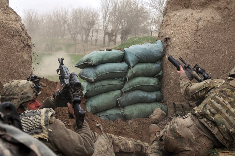 BALA MURGHAB, Afghanistan – Pfc. Ben Bradley (left), a Bulldog Troop, Red Platoon scout from the 7th Squadron, 10th Cavalry Regiment, ducks away from insurgent machine gun fire, as fellow scout Sgt. Jeff Sheppard, launches a M-203 grenade at the enemy’s position, during a combat engagement in northern Bala Murghab Valley, Badghis Province, Afghanistan April 4, 2011. Bradley, Sheppard, Air Force Tech. Sgt. Kevin Wallace, Navy Petty Officer 2rd Class Ryan Lee and his military working dog ‘Valdo’ were wounded by a rocket propelled grenade blast in the engagement. This photo was originally released April 7, 2011. (U.S. Air Force photo/Master Sgt. Kevin Wallace)