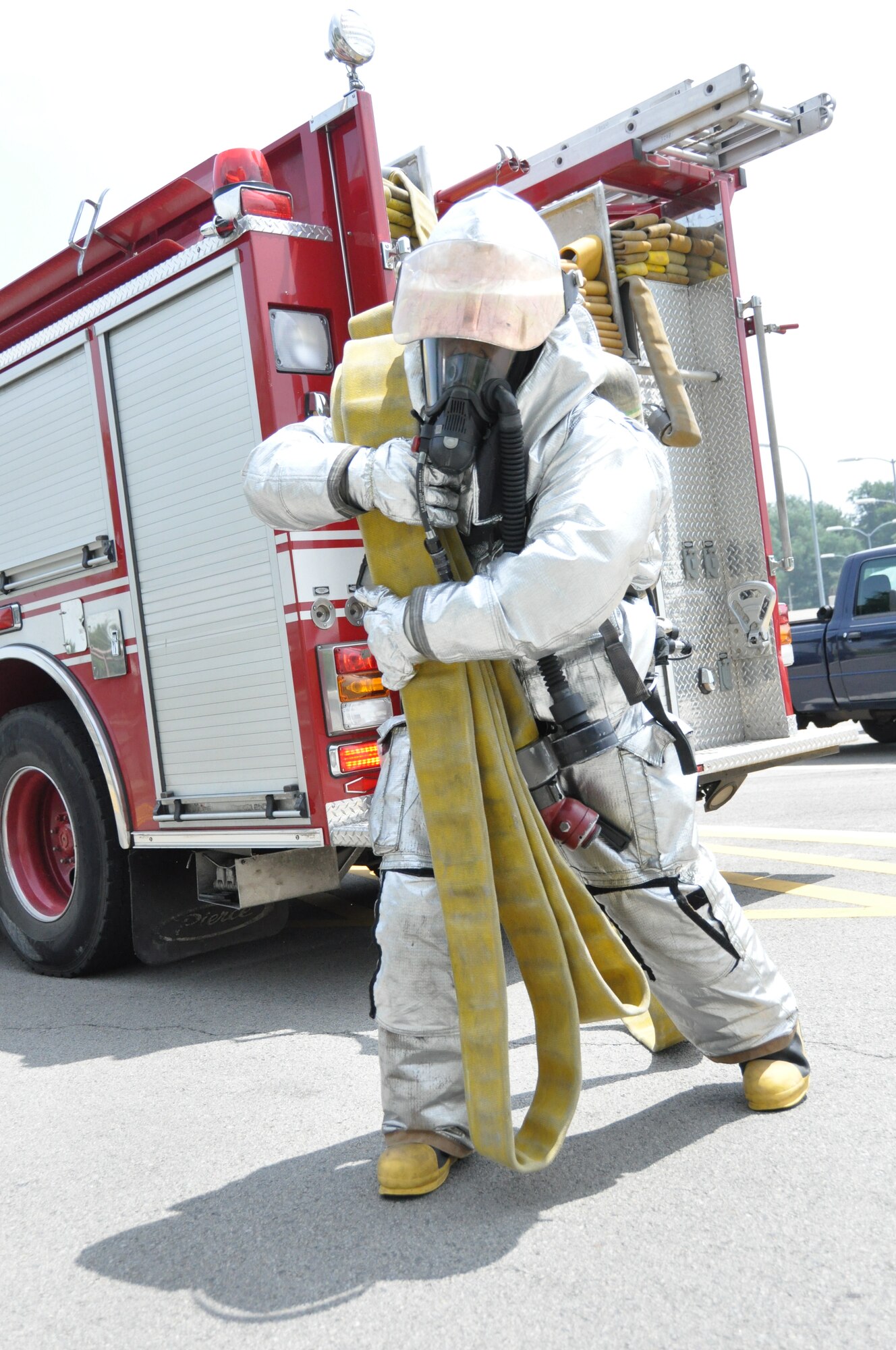 A firefighter from the 51st Civil Engineer Squadron rushes to clear a fire after an attack during operational readiness exercise Beverly Midnight 12-03 at Osan Air Base, Republic of Korea, July 25, 2012. Scenarios for the ORE include aircraft accidents, medical emergencies, building fires and chemical and missile attacks. Participants demonstrate the ability to administer self-aid and buddy-care and operate in a chemical environment. (U.S. Air Force photo/Senior Airman Michael Battles)