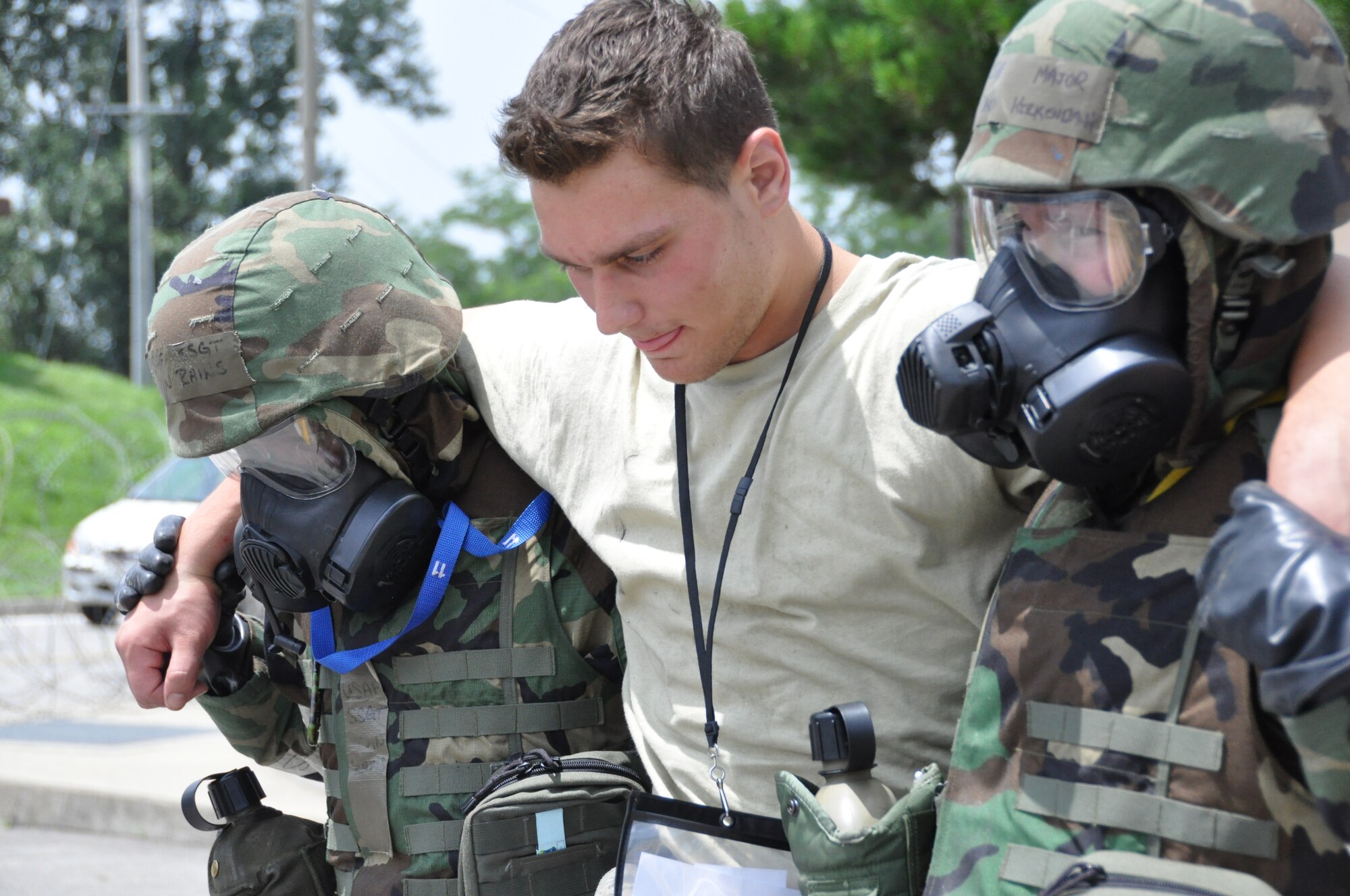 Airman 1st Class Phillip Makarenko, 51st Munitions Squadron, receives help from first responders after a chemical attack during operational readiness exercise Beverly Midnight 12-03 at Osan Air Base, Republic of Korea, July 25, 2012. During OREs such as BM 12-03 role players are used to simulate dead and injured victims.  BM 12-03 is the first ORE following the consolidated unit inspection in April. (U.S. Air Force photo/Senior Airman Michael Battles)