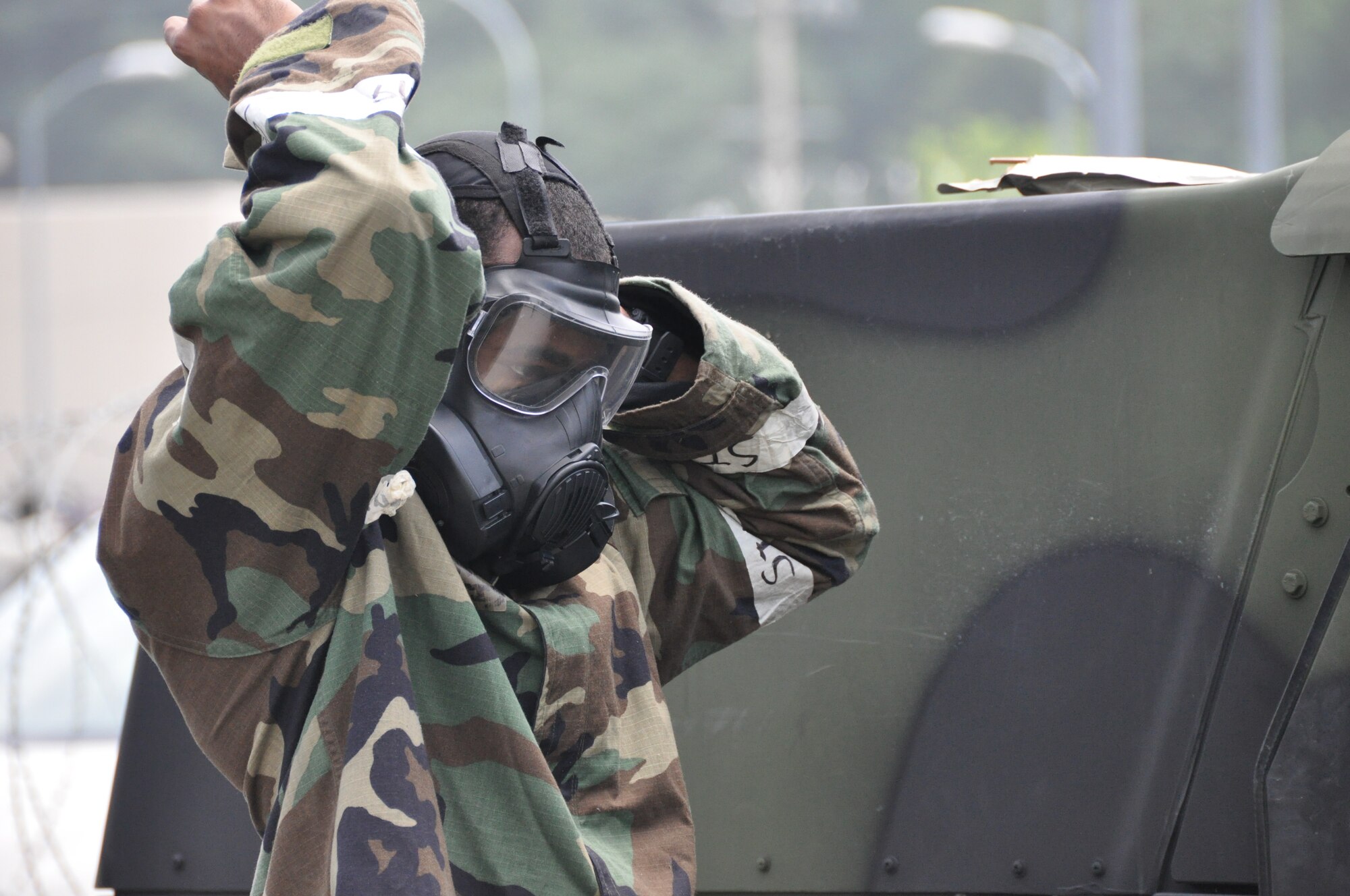 Senior Airman Ray Curtis, 51st Security Forces Squadron augmentee, dons his gas mask during a missile attack part of operational readiness exercise Beverly Midnight 12-03 at Osan Air Base, Republic of Korea, July 25, 2012. Airmen are provided by each base unit to augment the security needs of the base during real-world and exercise events. Curtis is assigned to the 51st Logistics Readiness Squadron. (U.S. Air Force photo/ Senior Airman Michael Battles)