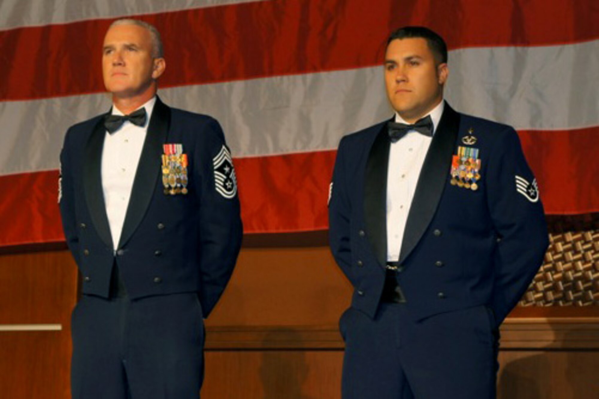 U.S. Air Force Chief Master Sgt. Brooke McLean, Pacific Air Forces command chief master sergeant, and Staff Sgt. Warren Williamson Jr., a medic with the 18th Medical Operations Squadron, stand at parade rest as the citation for Williamson's Vanguard Award is read at the Non-Commissioned Officer Association 2012 Annual Convention in Las Vegas, Nev., July 12, 2012. Williamson received the award for his heroic actions while deployed to Afghanistan last year. (Courtesy photo)