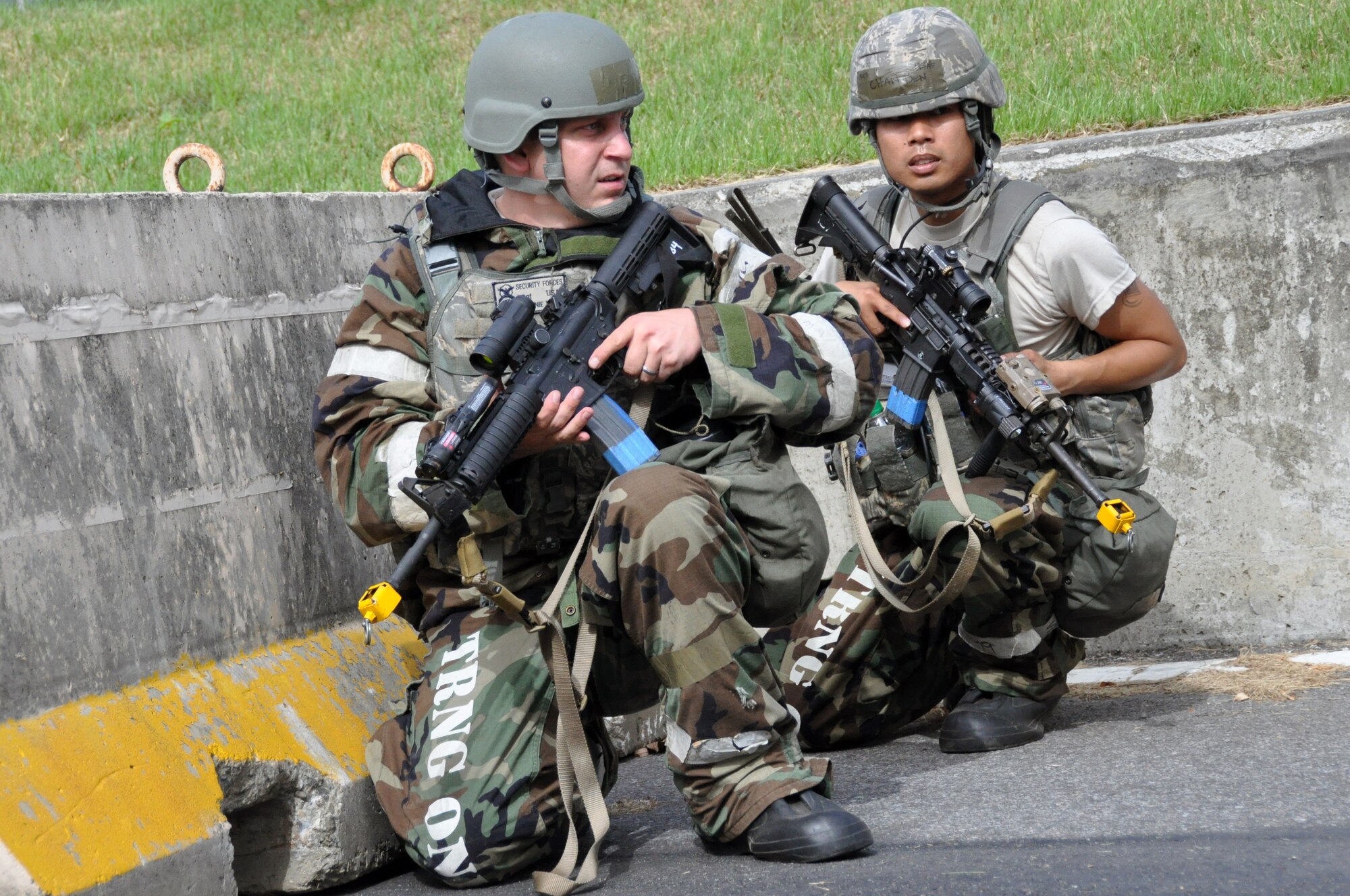 Senior Airman Benedict Chan (right) and another member of the 51st Security Forces Squadron, scan for opposing forces during operational readiness exercise Beverly Midnight 12-03 at Osan Air Base, Republic of Korea, July 25, 2012. Participants demonstrate the ability to administer self-aid and buddy-care and operate in a chemical environment.  BM 12-03 is the fourth ORE for Team Osan in 2012.  (U.S. Air Force photo/Senior Airman Michael Battles)