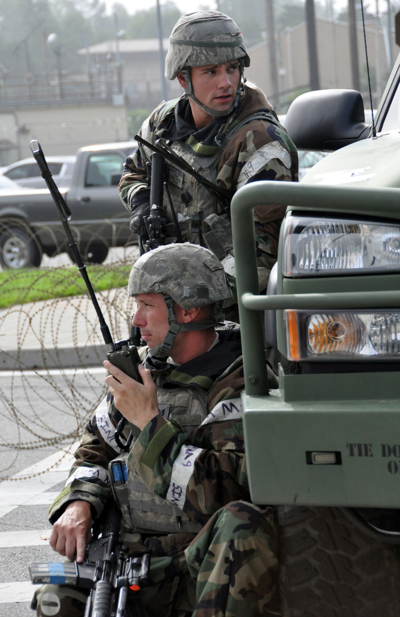 Tech. Sgt. James Nephew and Staff Sgt. Perry Vitali, both 51st Security Forces Squadron members, radio for backup forces during an attack by opposing forces part of operational readiness exercise Beverly Midnight 12-03 at Osan Air Base, Republic of Korea, July 25, 2012. During the week, Airmen will showcase their ability to position, employ and sustain forces during a variety of simulated attacks and situations. Participants also demonstrate the ability to administer self-aid and buddy-care and operate in a chemical environment. (U.S. Air Force photo/Senior Airman Michael Battles)