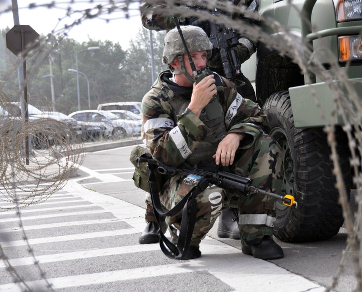 Tech. Sgt. James Nephew, 51st Security Forces Squadron member, radios for backup forces during an attack by opposing forces part of operational readiness exercise Beverly Midnight 12-03 at Osan Air Base, Republic of Korea, July 25, 2012. Scenarios for the ORE include aircraft accidents, medical emergencies, building fires and chemical and missile attacks. BM 12-03 is the fourth ORE for Osan in 2012. (U.S. Air Force photo/Senior Airman Michael Battles)