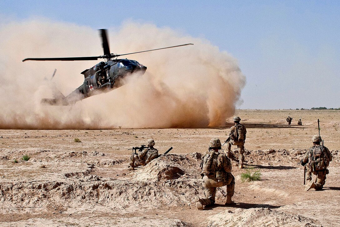 A UH-60 Black Hawk medical evacuation helicopter lands as U.S. Army paratroopers secure the area in Afghanistan's Ghazni province, July 23, 2012. The helicopter crew is assigned to the 82nd Combat Aviation Brigade. The soldiers evacuated a wounded insurgent.