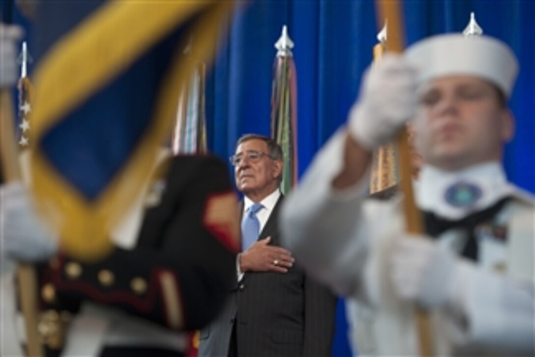 Secretary of Defense Leon E. Panetta stands for the National Anthem at the Defense Intelligence Agency change of directorship at Joint Base Anacostia-Bolling, on July 24, 2012.  Army Lt. Gen. Ronald Burgess Jr. is turning over directorship of the DIA to Lt. Gen. Michael Flynn.  