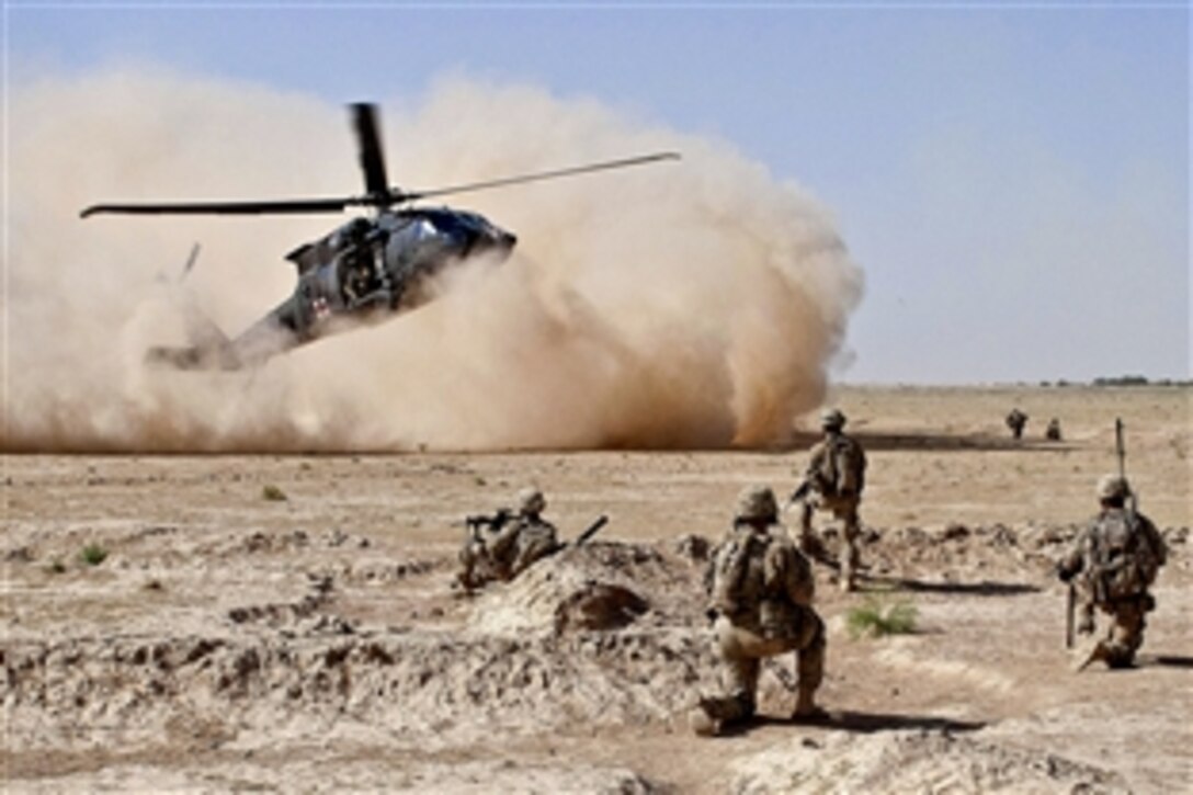 A UH-60 Black Hawk medical evacuation helicopter lands as U.S. Army paratroopers secure the area in Afghanistan's Ghazni province, July 23, 2012. The soldiers are assigned to the 82nd Airborne Division’s 1st Brigade Combat Team and the helicopter crew is assigned to the 82nd Combat Aviation Brigade. The soldiers evacuated a wounded insurgent.